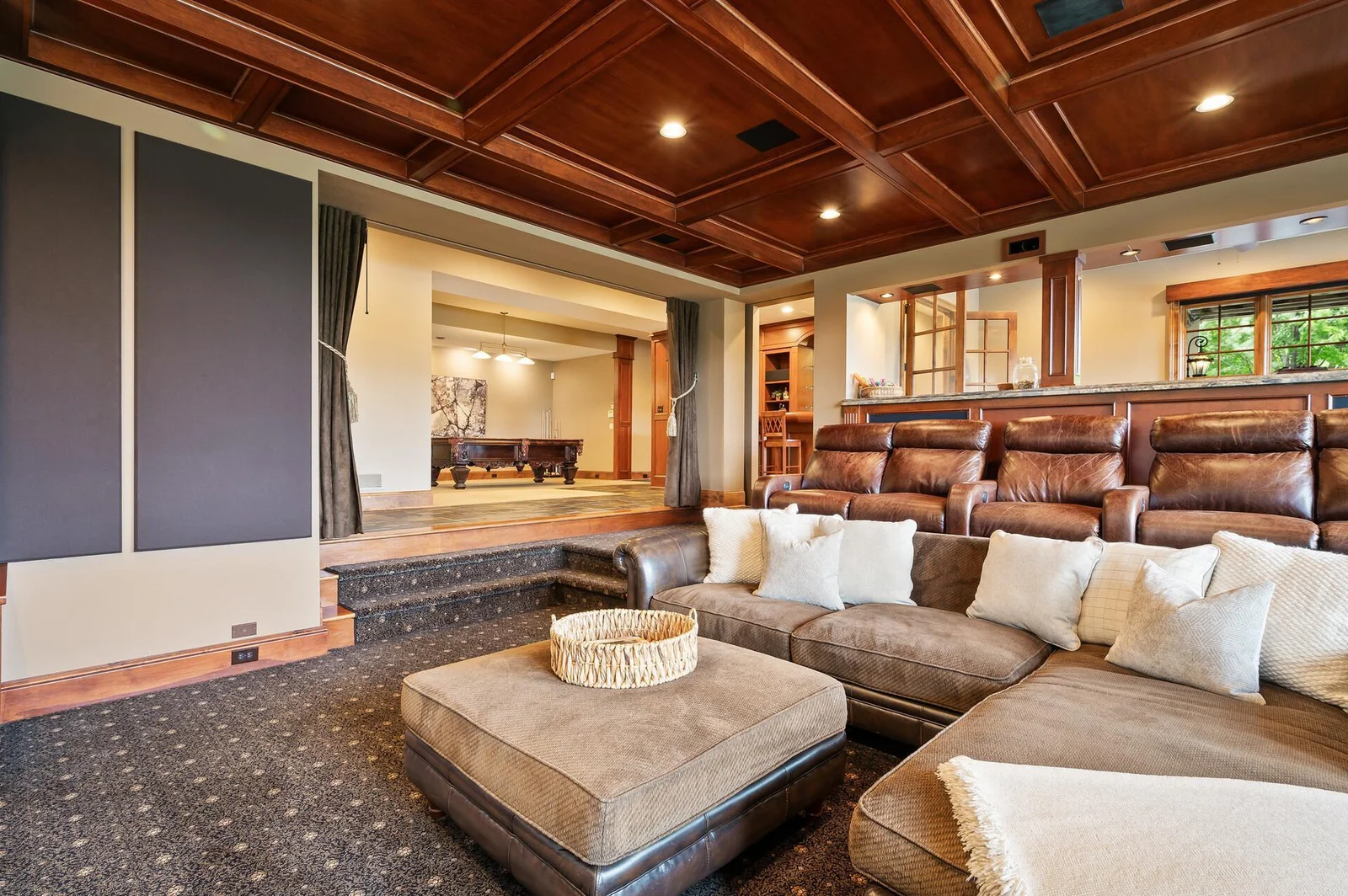 The theater room features a significant investment in high-end wool carpet, providing a luxurious feel.