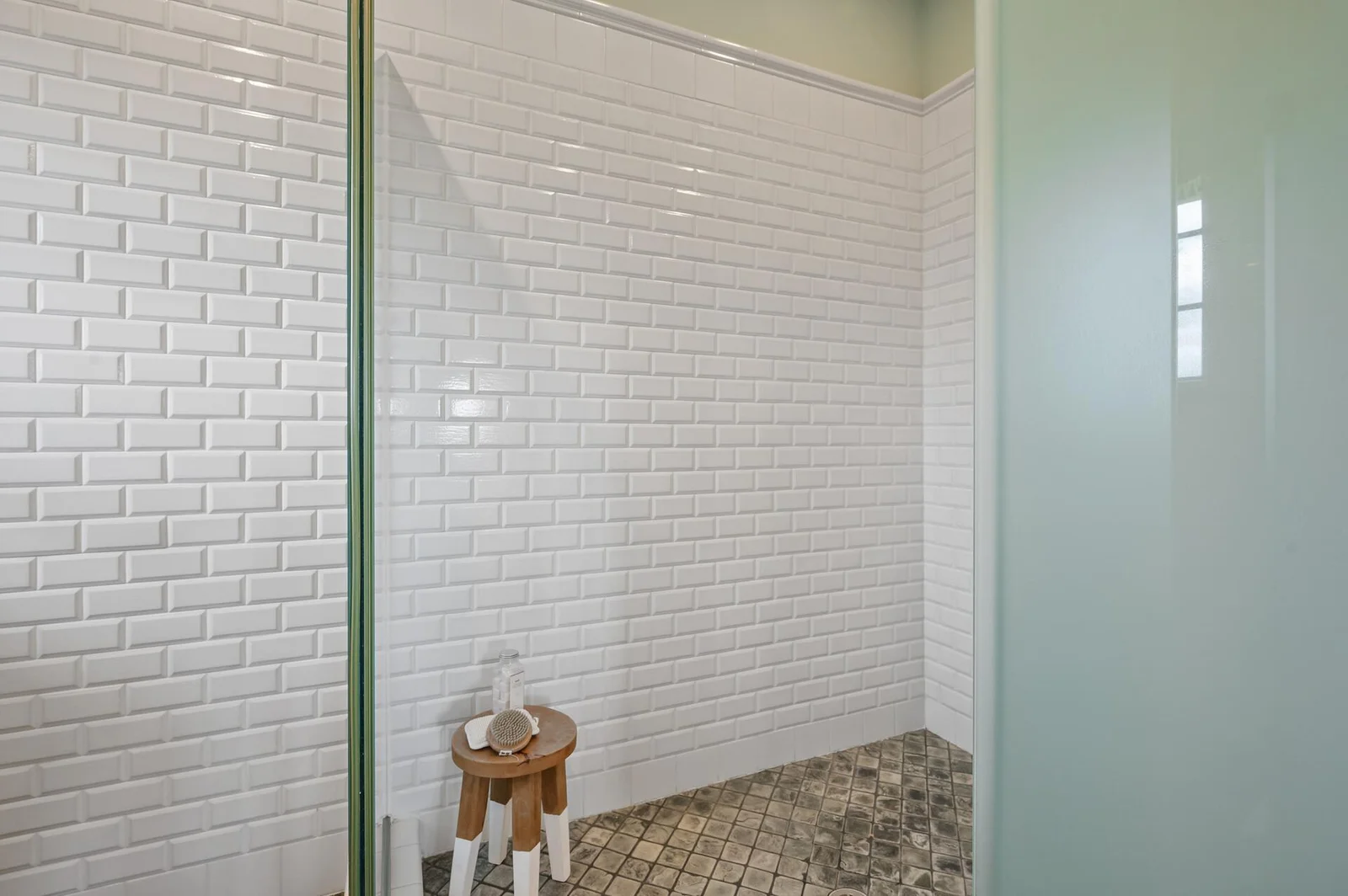 Beautiful subway tile detail in the spacious separate shower of the primary ensuite.