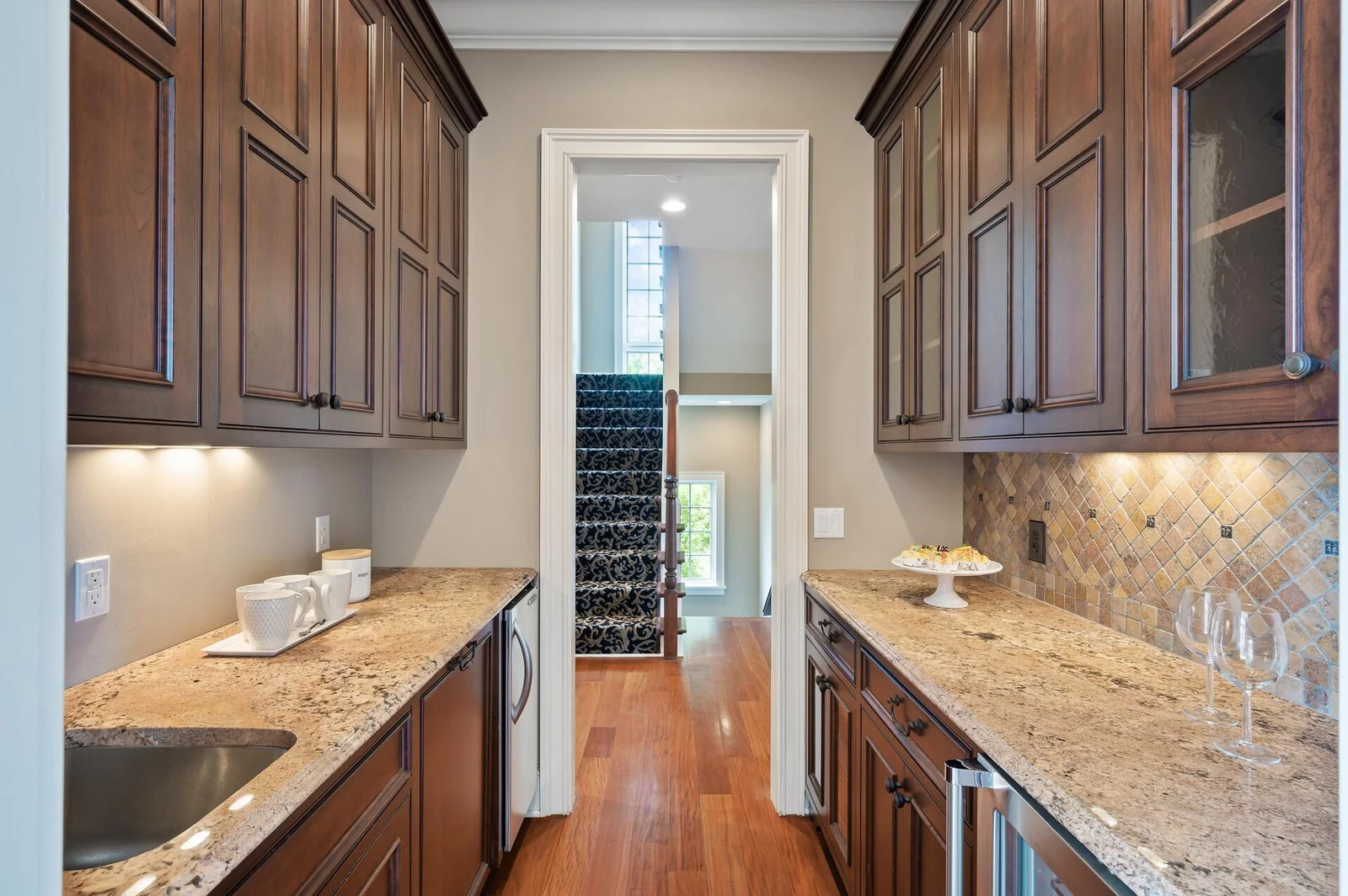 The well-appointed butler's pantry, with its ample counter space and cabinetry, provides a serving and staging area.