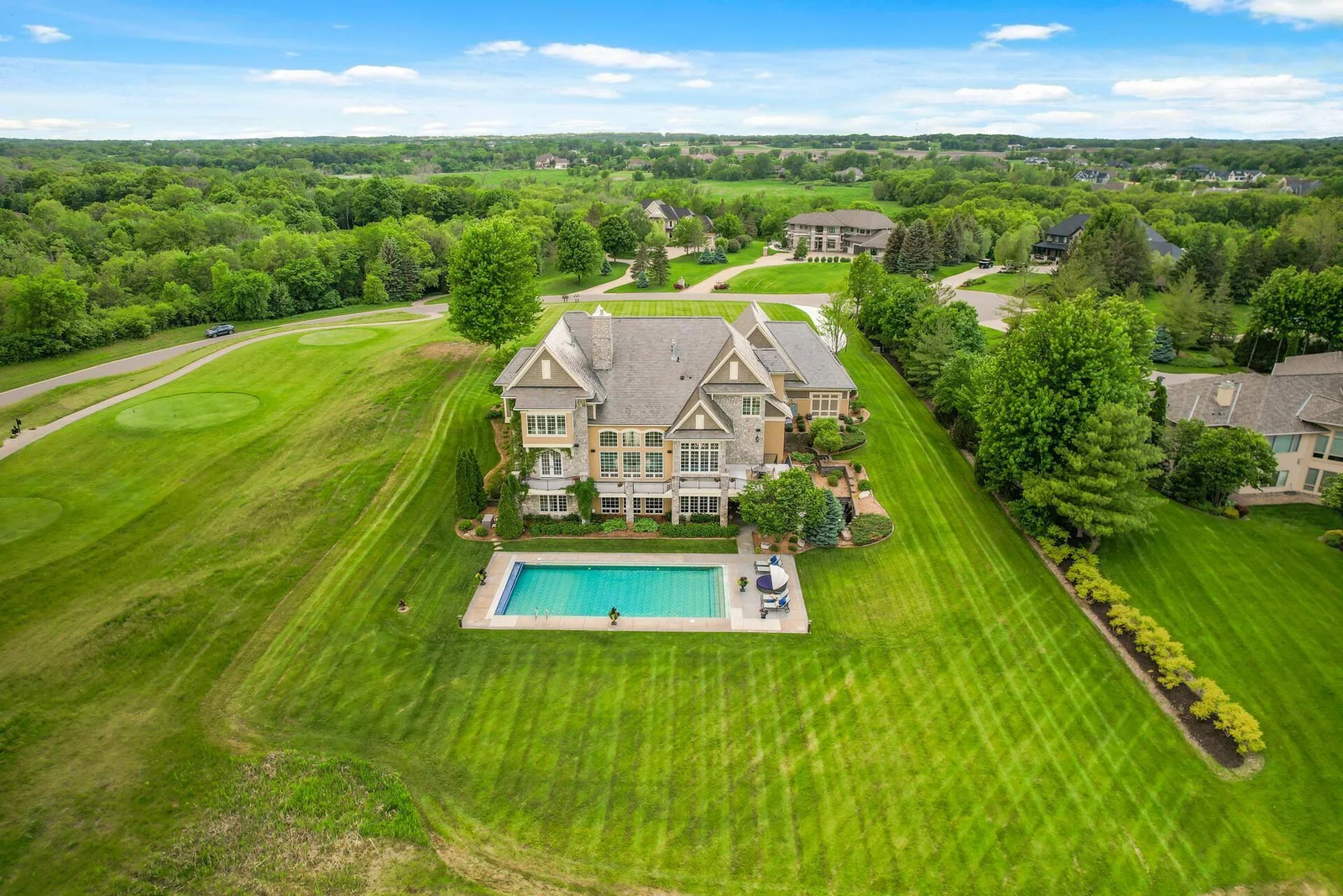 A breathtaking aerial view of your private retreat, featuring a beautiful pool and expansive yard.