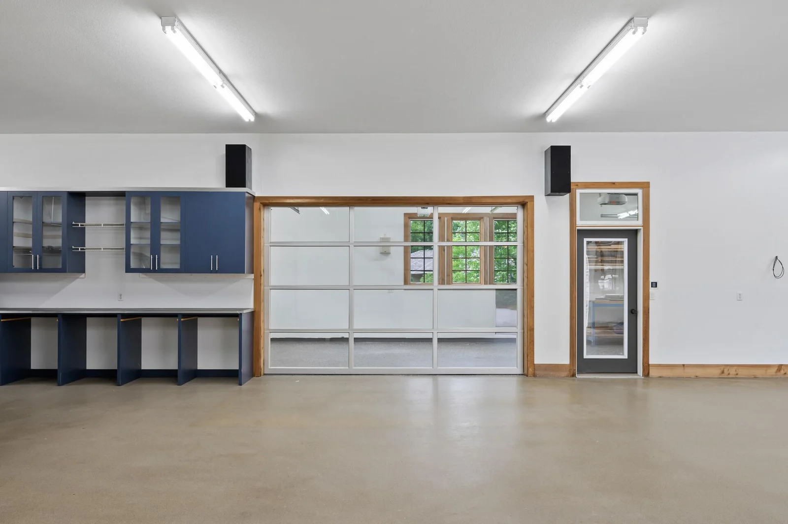 Heated flex room with a glass garage door entrance – a unique and versatile space within the 6-car garage.