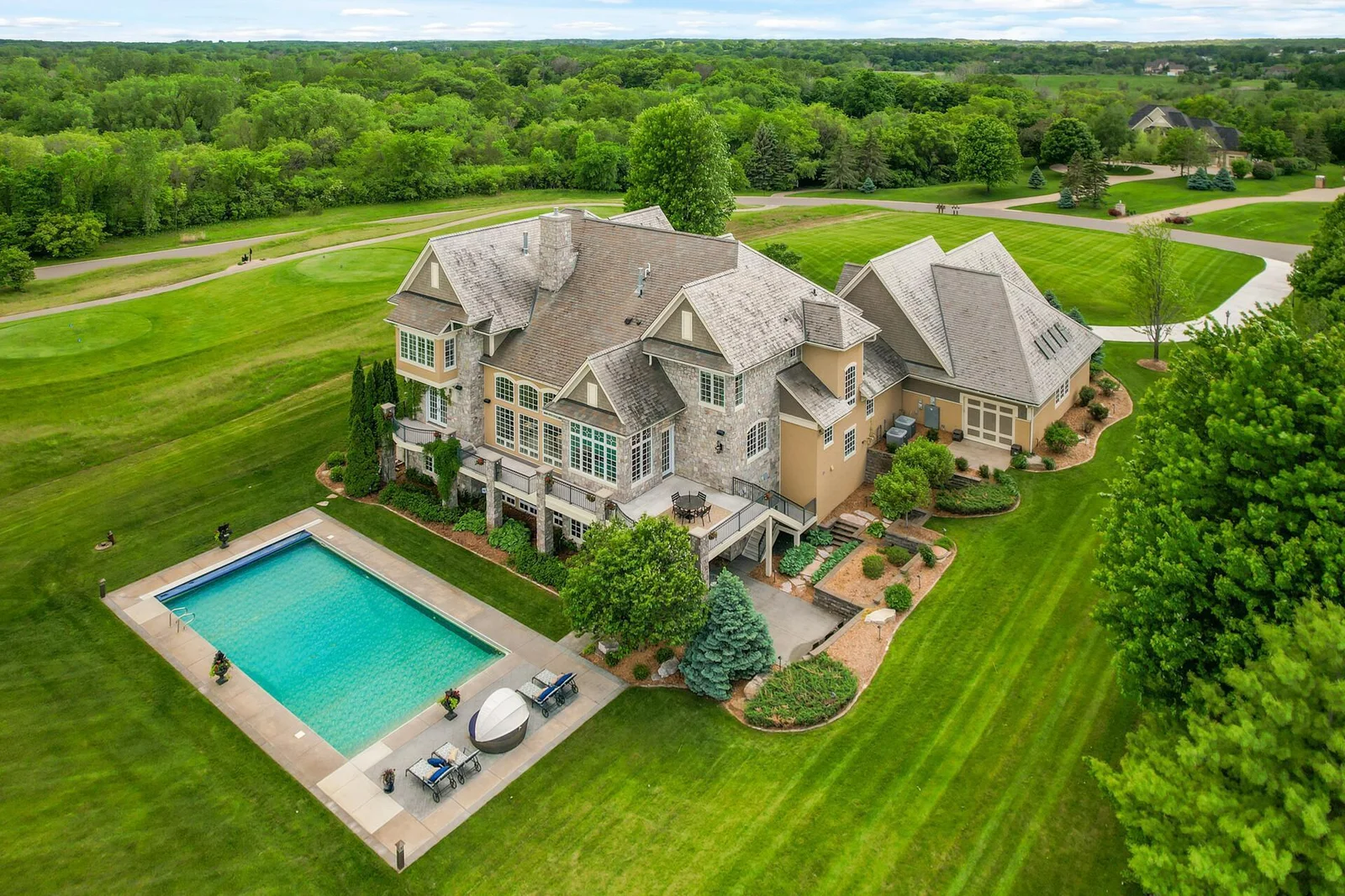 The grandeur of this residence is evident, complete with a stunning in-ground heated pool area for outdoor enjoyment.