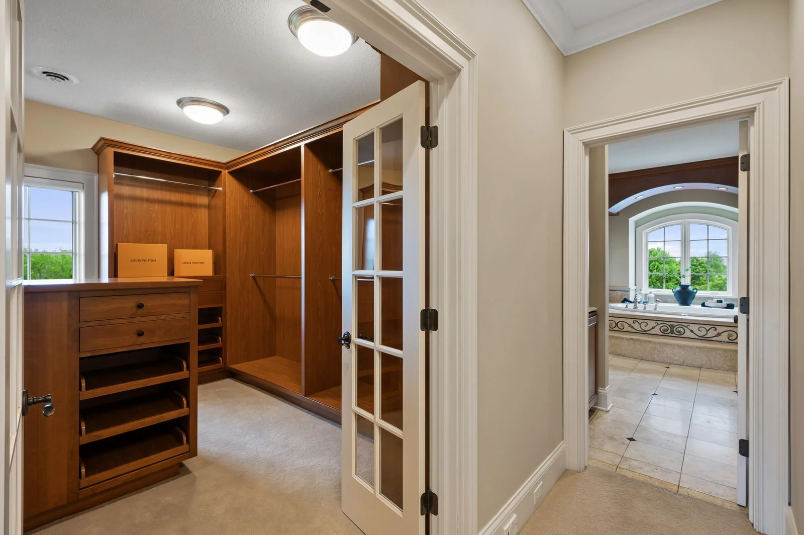 Enjoy a seamless flow from the luxurious bathroom to this well-appointed walk-in closet, creating a private and organized dressing area.