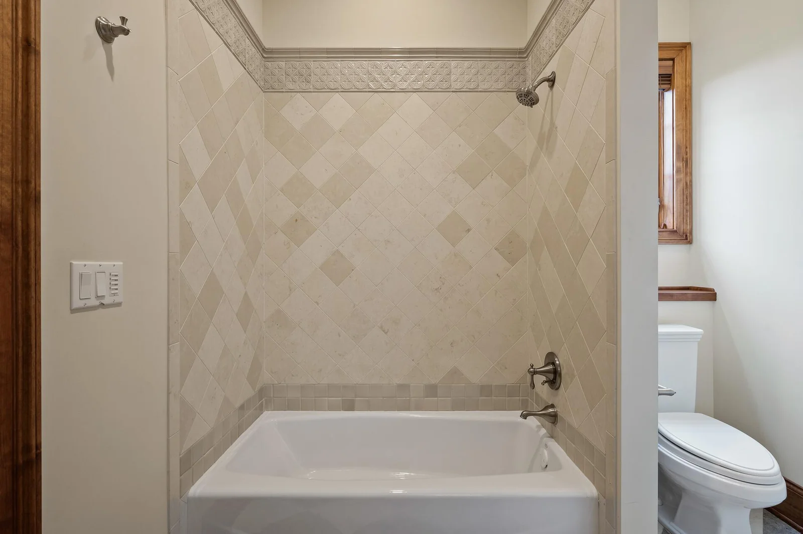 This ensuite bathroom, serving the lower level bedroom, is well-appointed with a bathtub and shower combination.