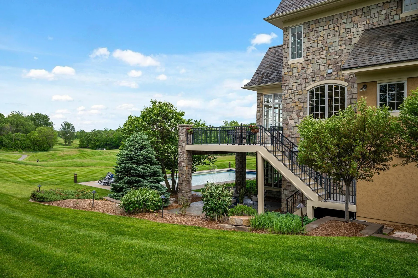 Enjoy your private pool and upper deck, all while overlooking the expansive backyard and views of the golf course.