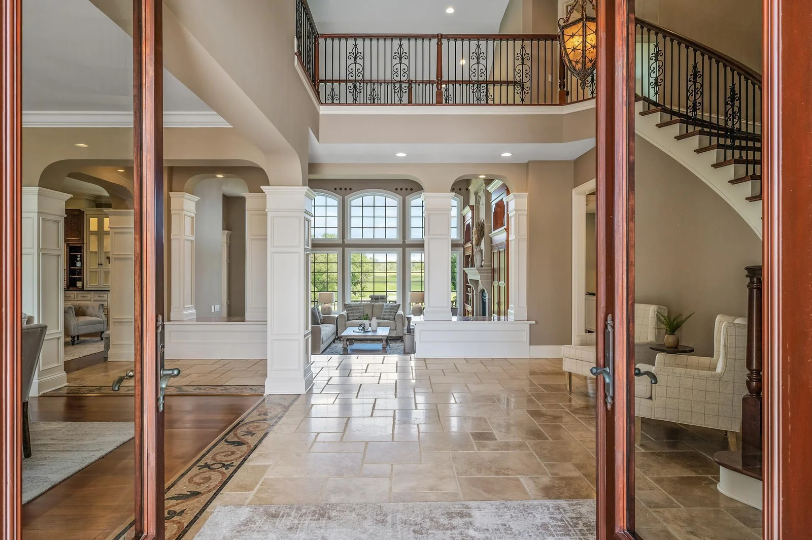 Impressive two-story foyer welcomes you with its soaring ceilings and architectural details.
