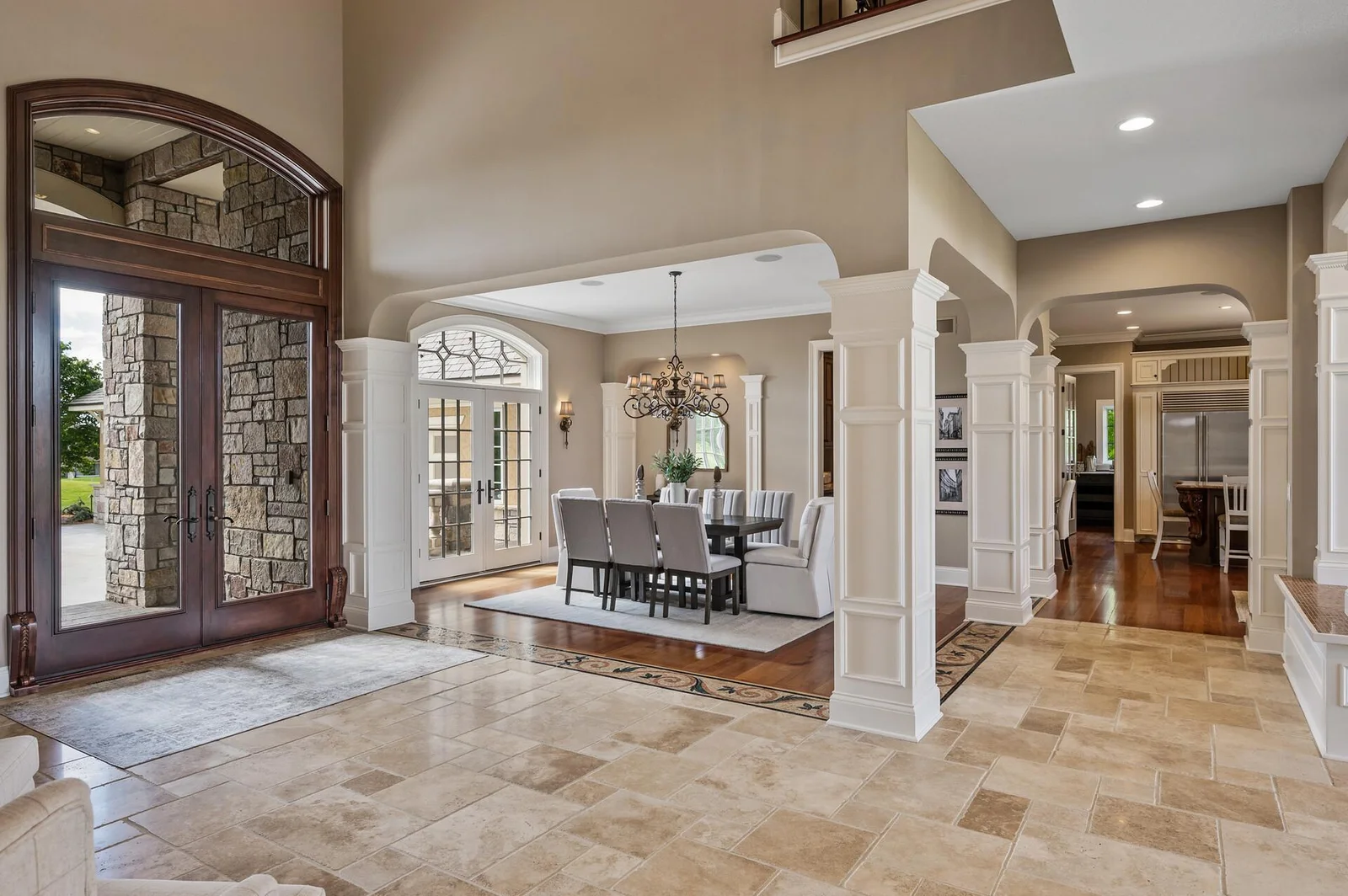 The grand foyer flows seamlessly into the formal dining room.