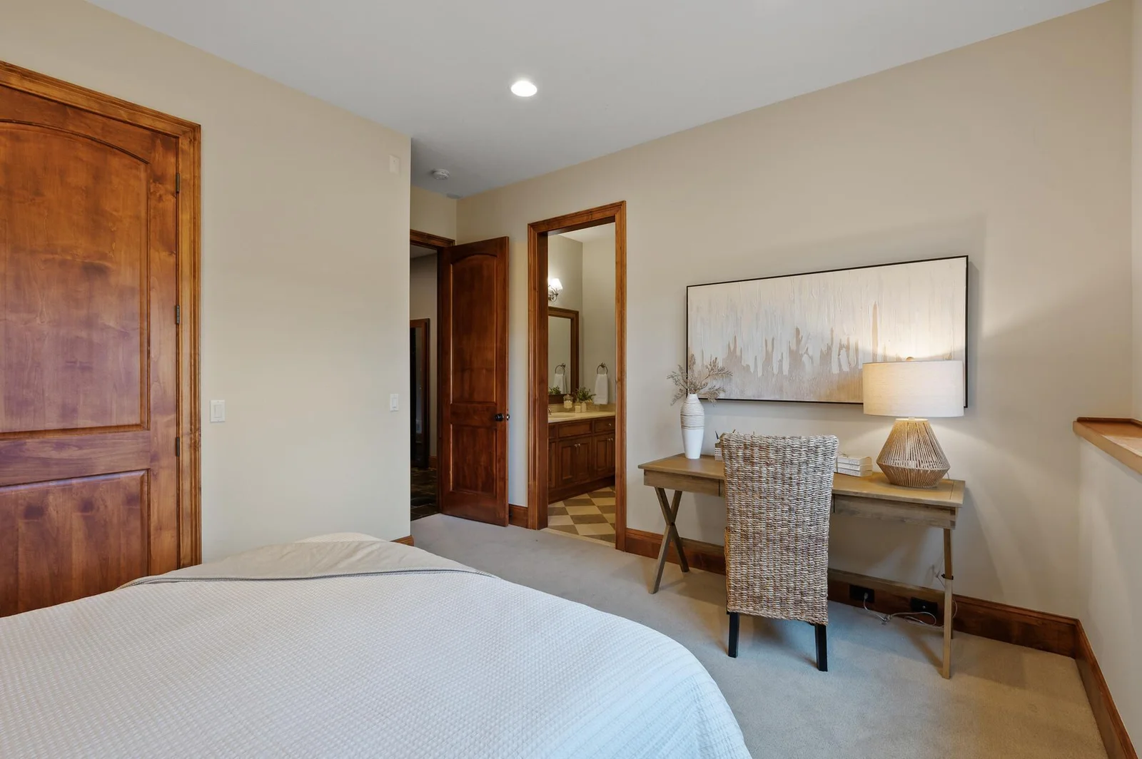 This lower level bedroom functions as a private suite with its own ensuite bathroom.