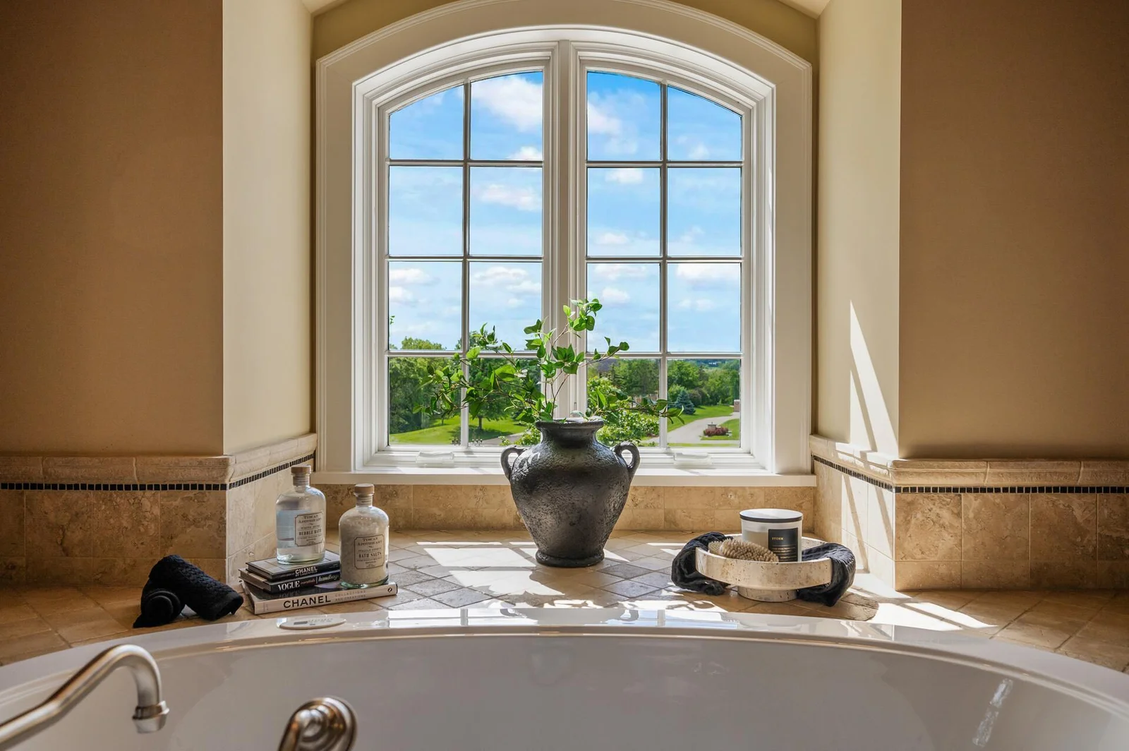 Elegant details surround the soaking tub, creating a perfect spot to unwind and enjoy the view.