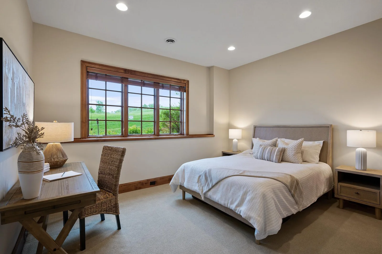 Bright and welcoming, this lower level bedroom provides a comfortable space for guests or family.