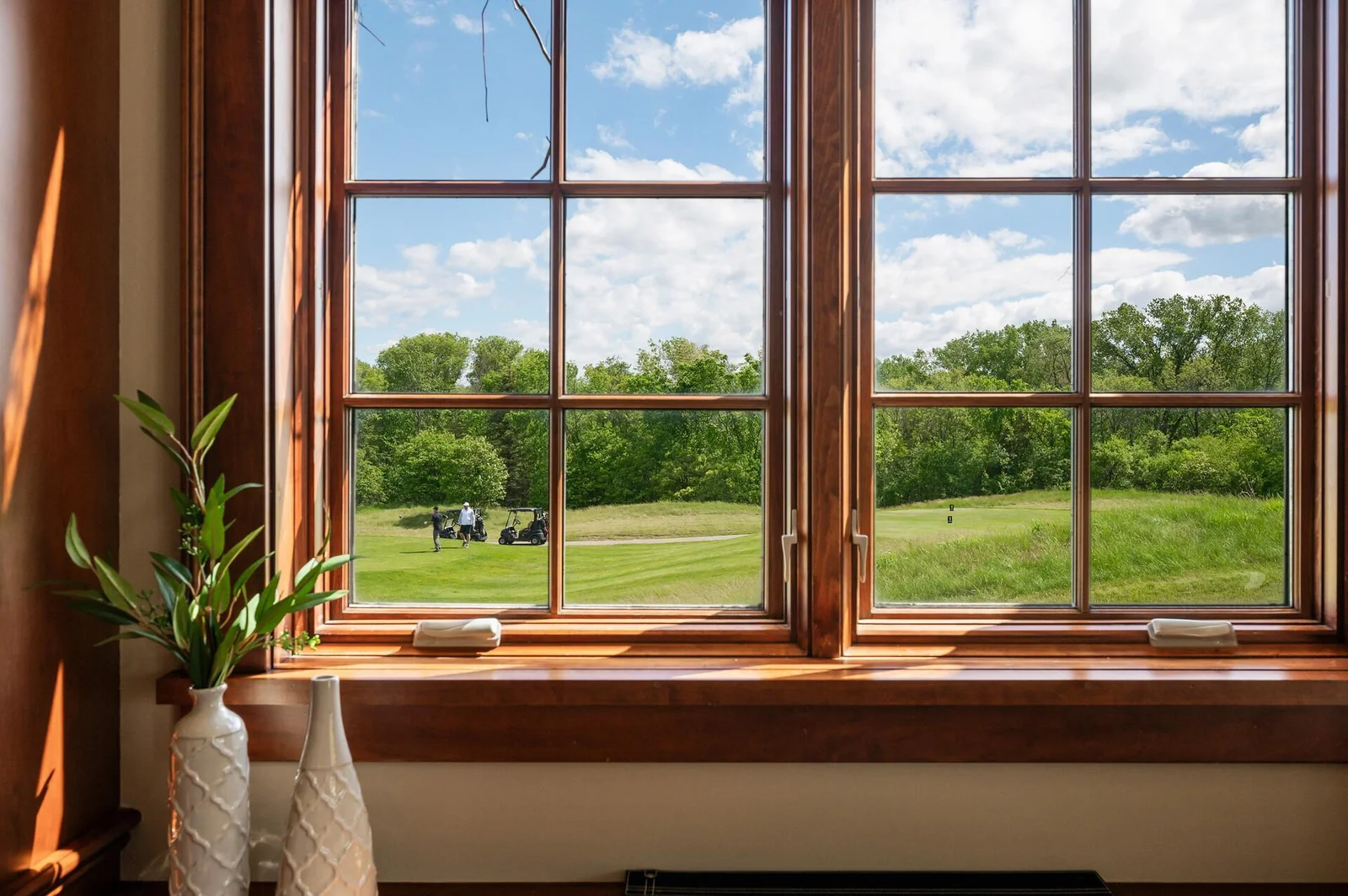 The elegant office features large windows and sweeping views.