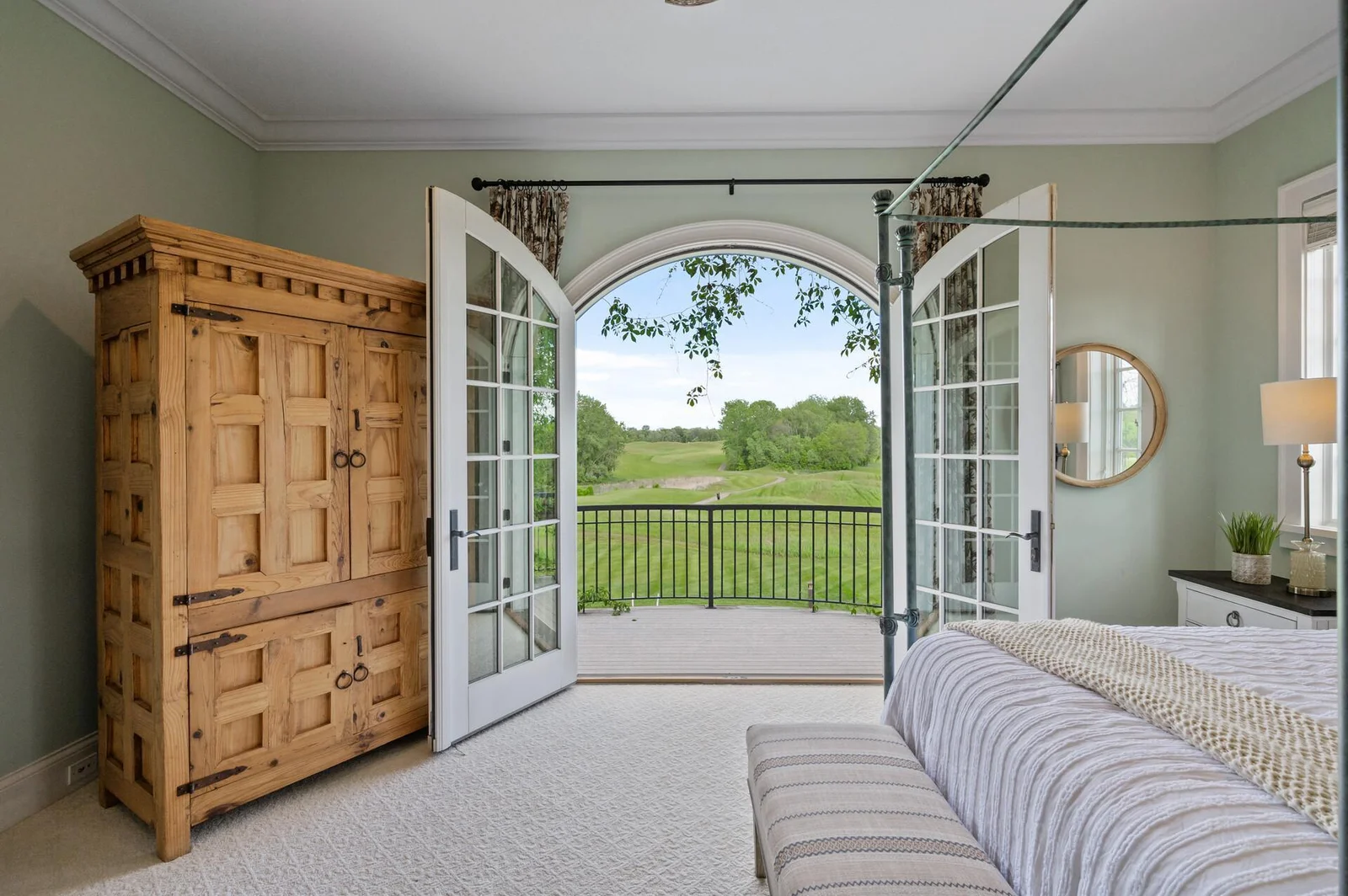 Immerse yourself in the beauty of the surroundings from the comfort of the main-level primary suite, offering direct access to the golf course views.