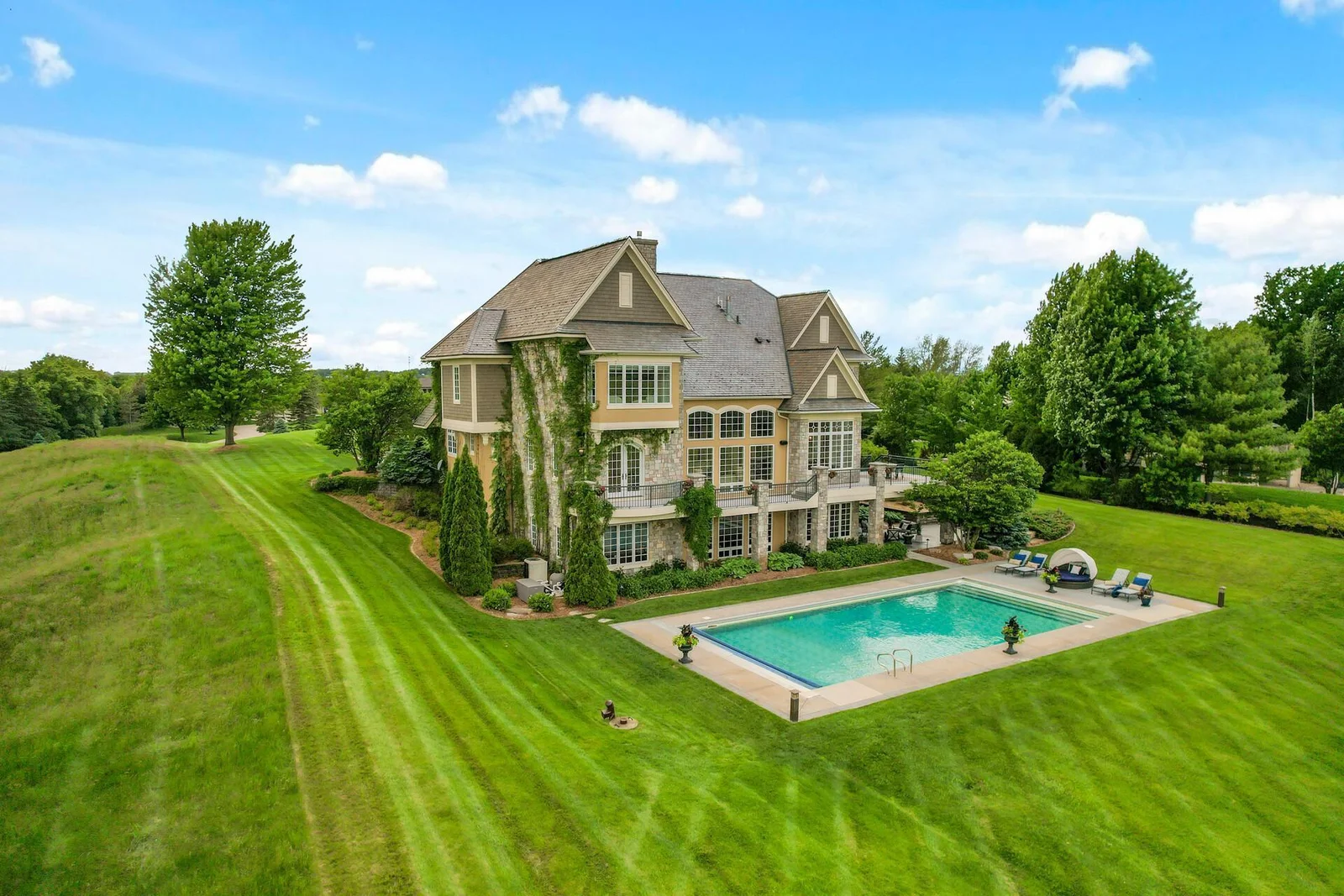 Imagine enjoying the privacy and luxurious outdoor amenities, including the pool, on the expansive grounds.