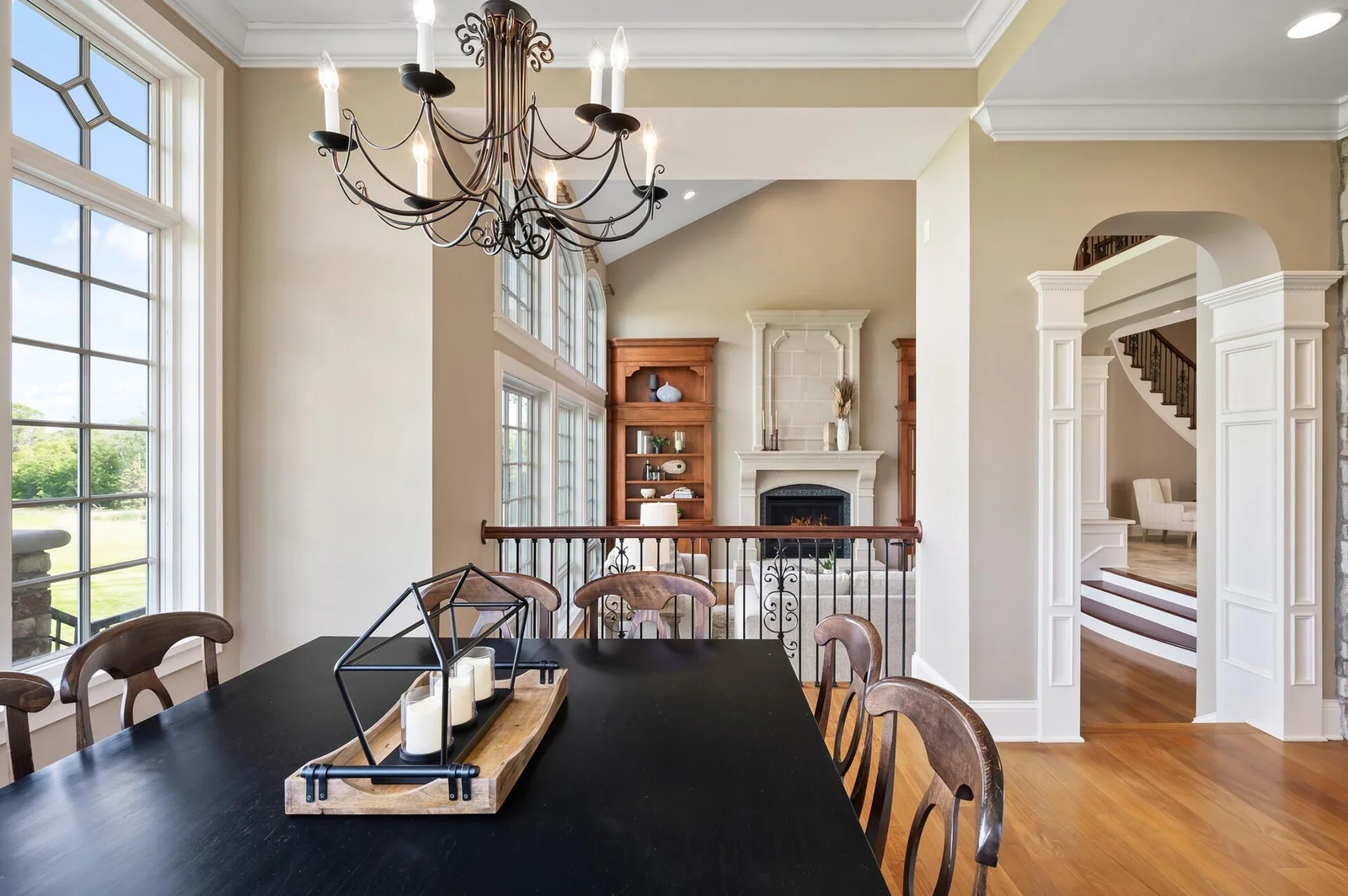 Charming informal dining area with bright windows, looking out onto the expansive living room.