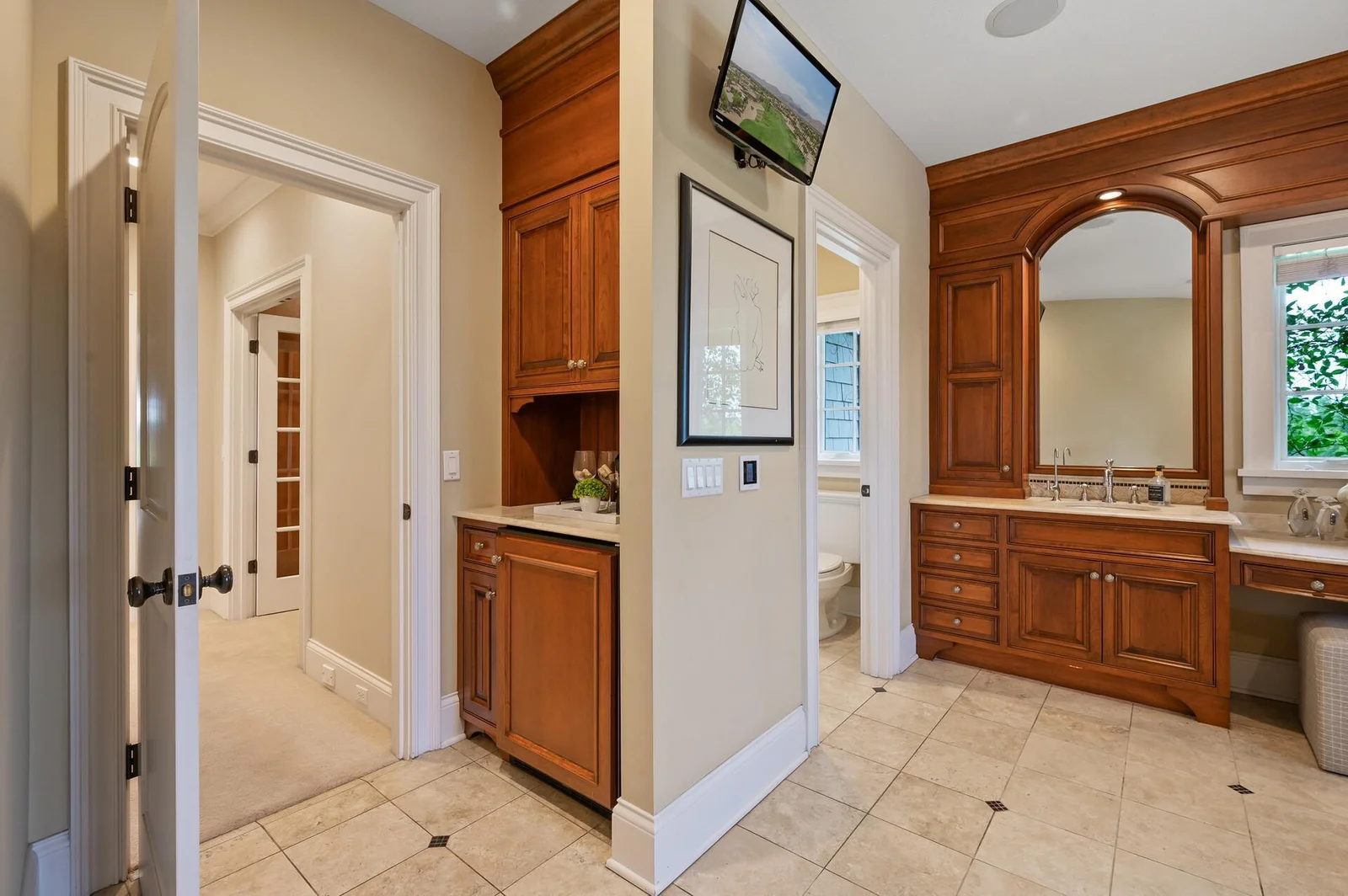 Thoughtfully designed for comfort and luxury, this transition area connects the spacious second primary suite to its beautiful bathroom.