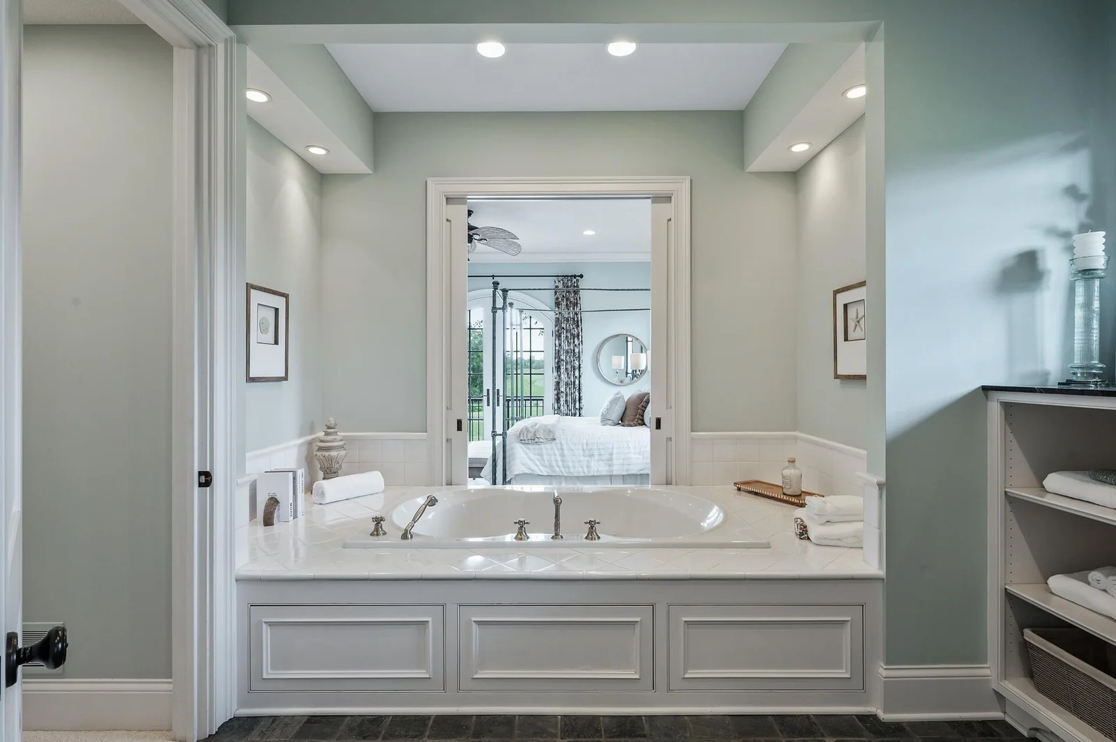 Soak in luxury with this beautifully situated tub, offering a serene view towards the primary bedroom. A seamless flow enhances the spa-like feel of this primary ensuite.