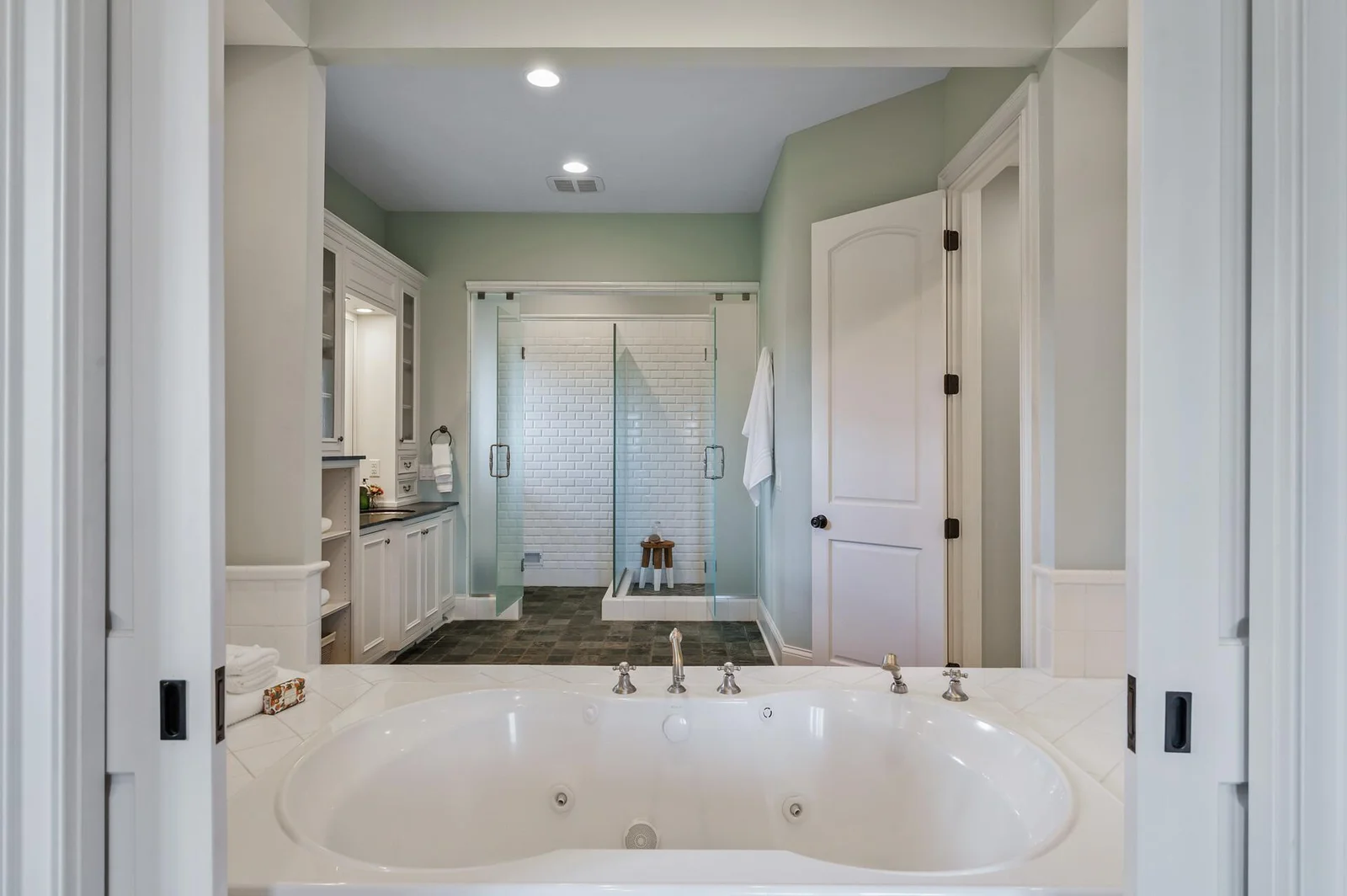 Beautifully appointed, the primary ensuite features a relaxing soaking tub, separate tiled shower, and stylish finishes.