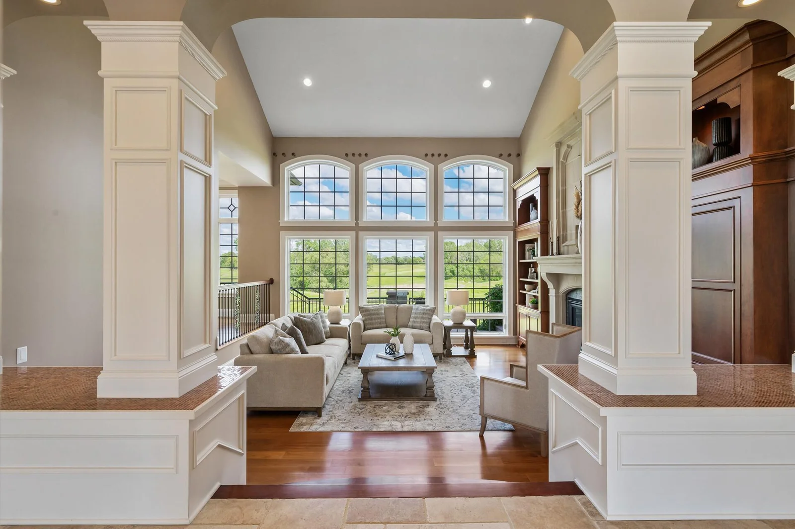 Breathtaking golf course views flood the living room through its expansive windows.