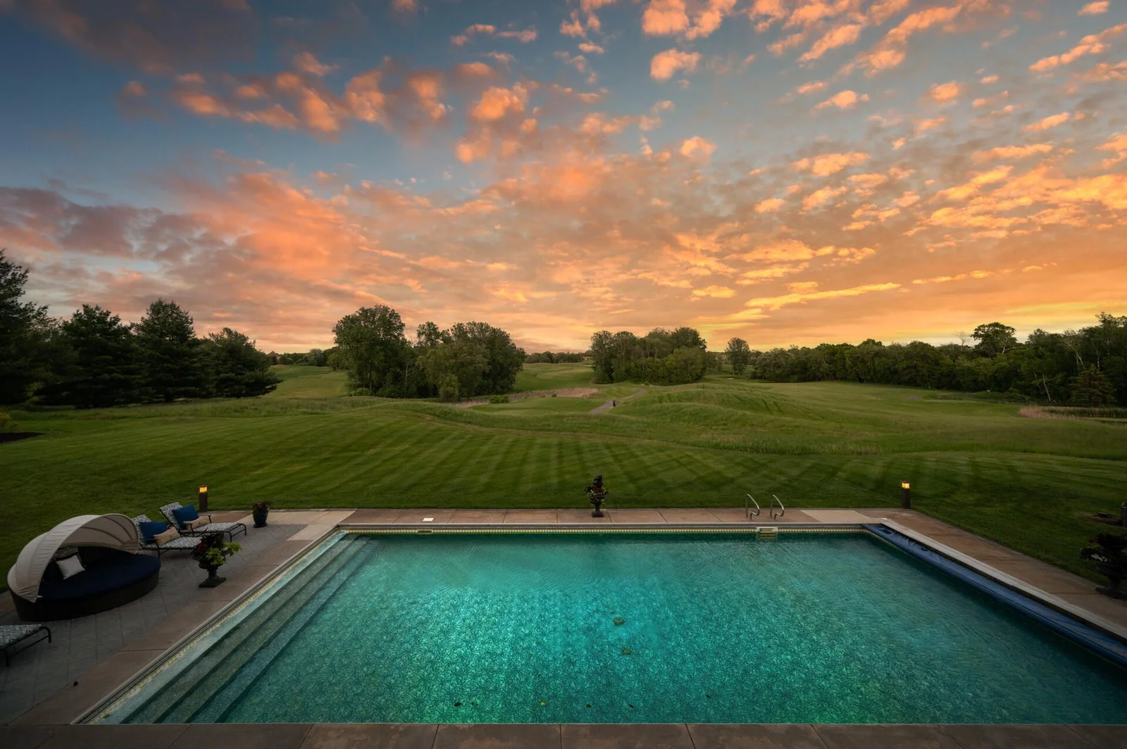 An awe-inspiring view of your pool and the bordering golf course.