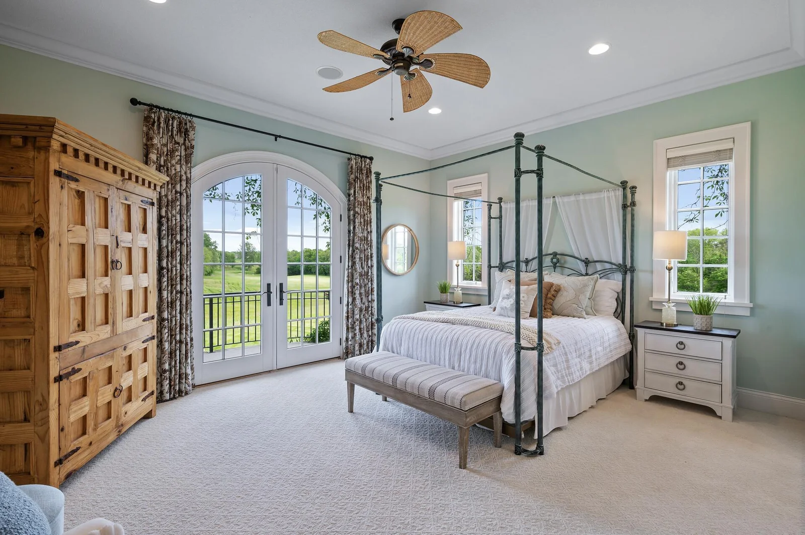 This main-level primary suite boasts French doors leading to the outdoors, creating a peaceful retreat and offering a choice alongside a second primary suite on the upper level.