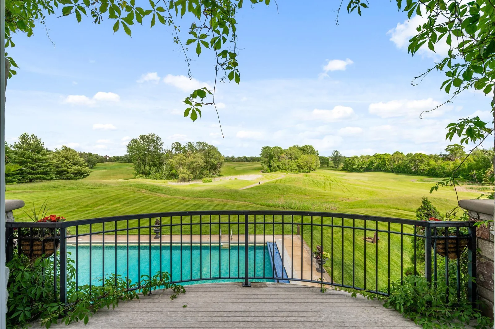 Enjoy stunning panoramic views of the pool and golf course from the private balcony of the main-level primary suite.