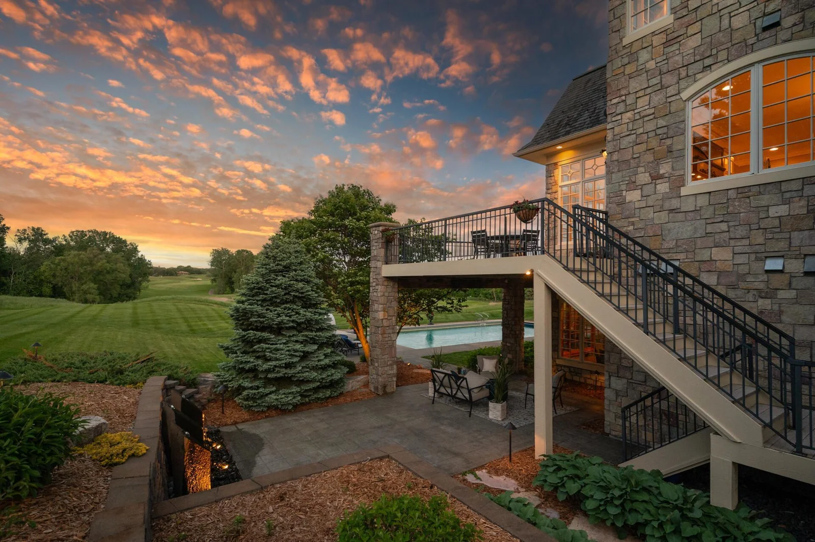 Capture the unique evening perspective from the upper deck and lower patio, offering stunning views of the pool and golf course.