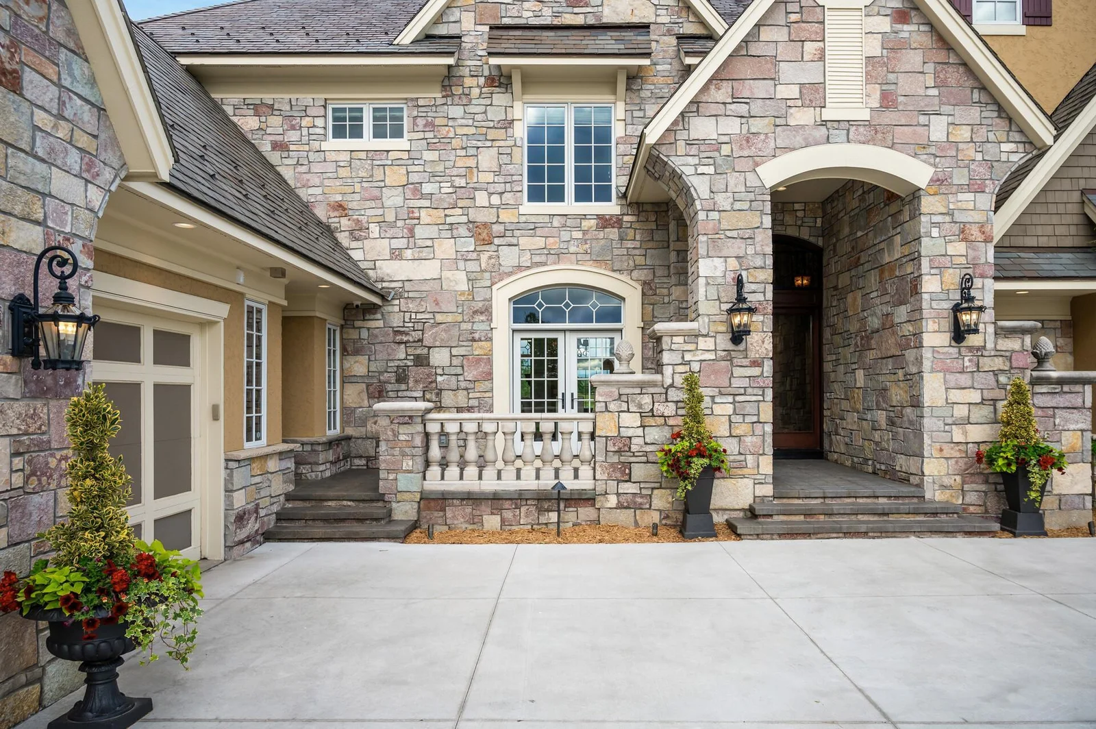 The intricate stonework and architectural elements of this craftsman-style home create a striking first impression.