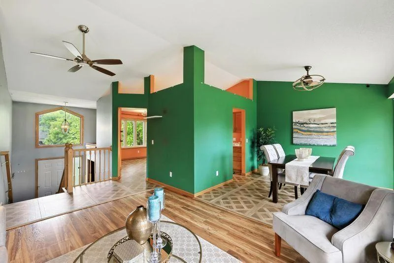 Main level living room with vaulted ceilings (In process of getting walls painted and carpet in living room/hallway, LVP in dining/kitchen