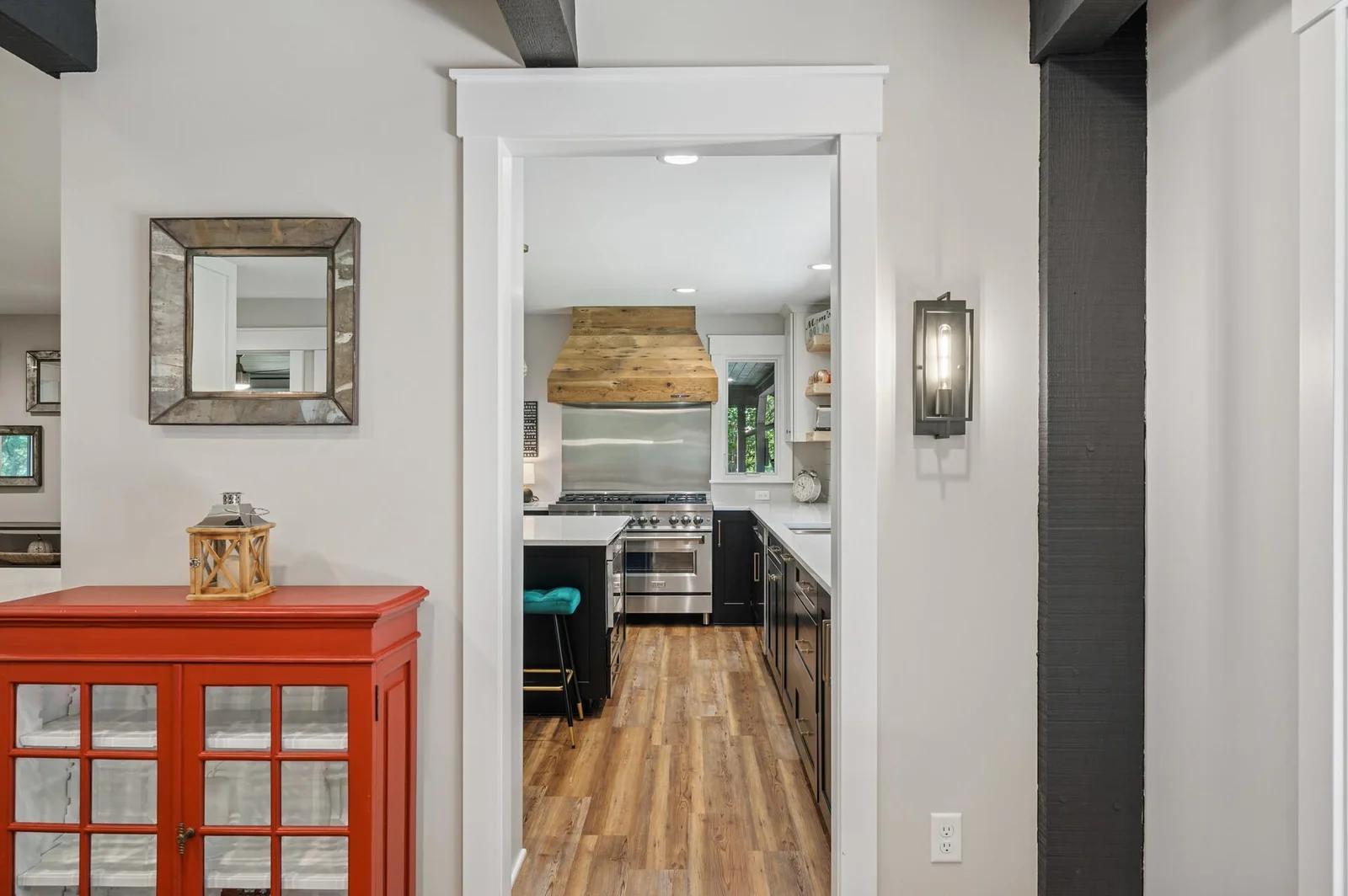 Where the original flagstone floor ends, new wood plank luxury flooring extends through main level.