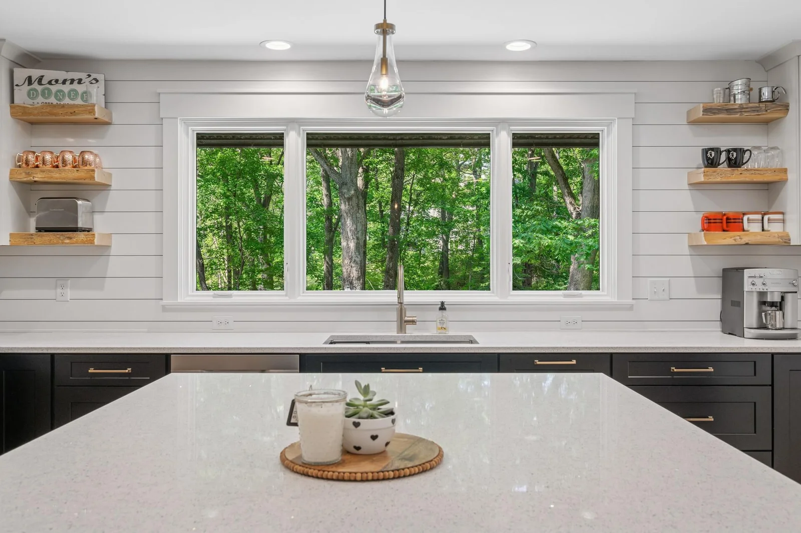 Ship lap backsplash, massive quartz center island and tons of natural light through new Pella windows.