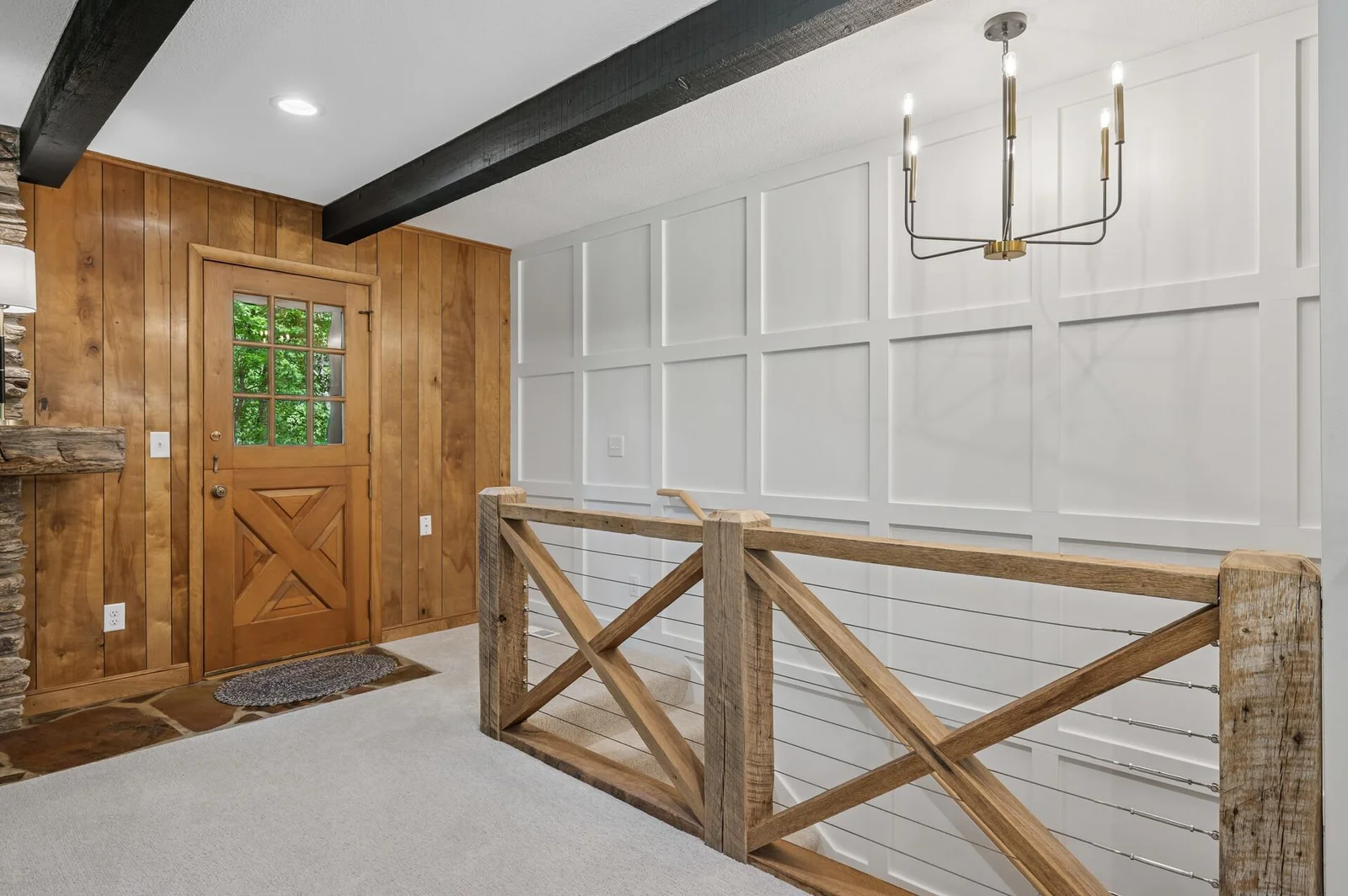 Beautiful custom reclaimed wood stair railing and modern panel accent wall lead you to the newly finished lower level, or outside to the back deck.