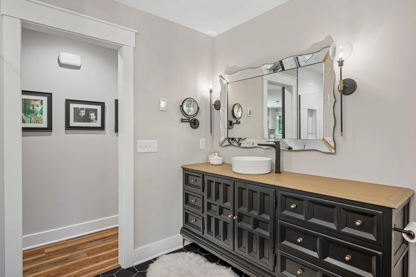Full bathroom on main level is spa like with custom vanity, tile floor and seperate soaking tub and luxury shower.