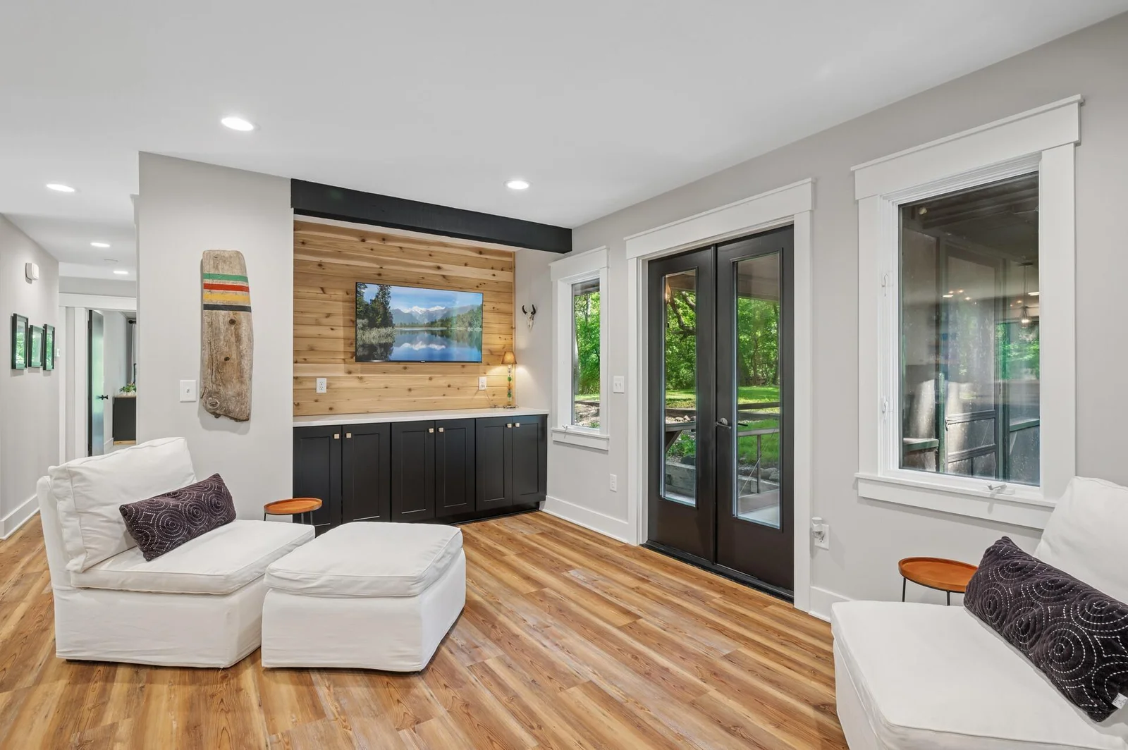 Custom built in buffet with wood plank accent provides a perfect spot to relax or entertain right off the kitchen.