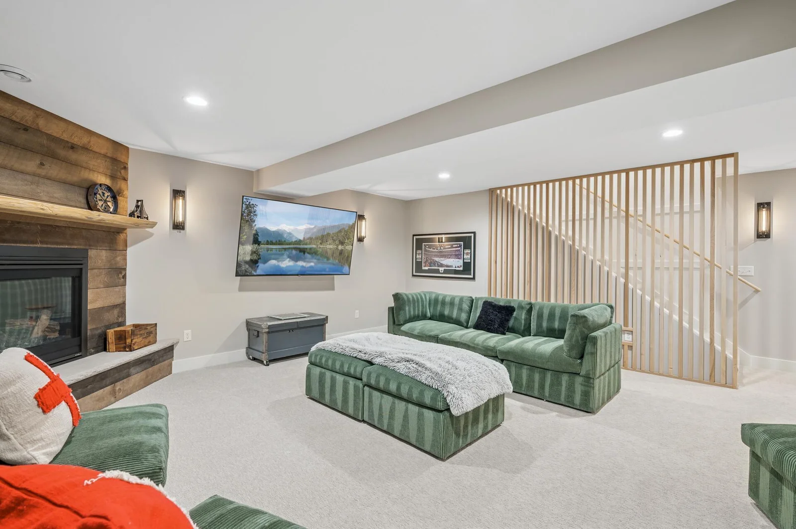 Large entertaining space with gas fireplace accented with wooden planks, 2 additional bedrooms, spa, wet bar, and 3/4 bathroom complete the lower level addition.