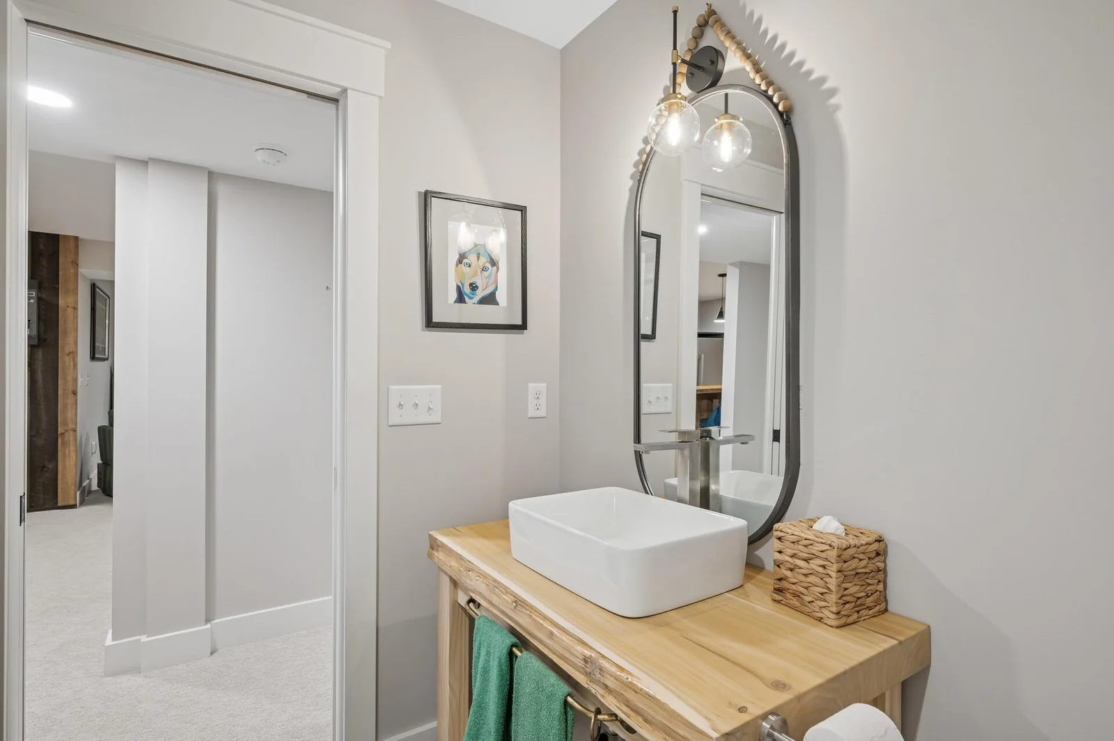 Lower level 3/4 bathroom with custom live edge slab vanity, custom hardware (from a sailboat mast!) and full size shower.