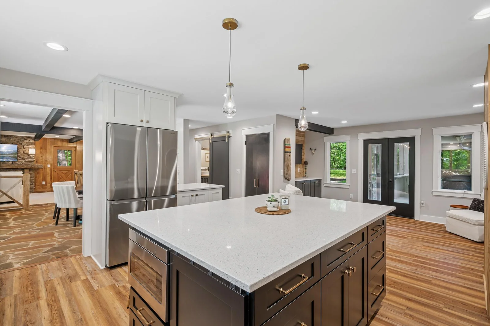 Open concept main floor is great for entertaining.  French doors lead to covered breezeway for access to large screened in porch area.