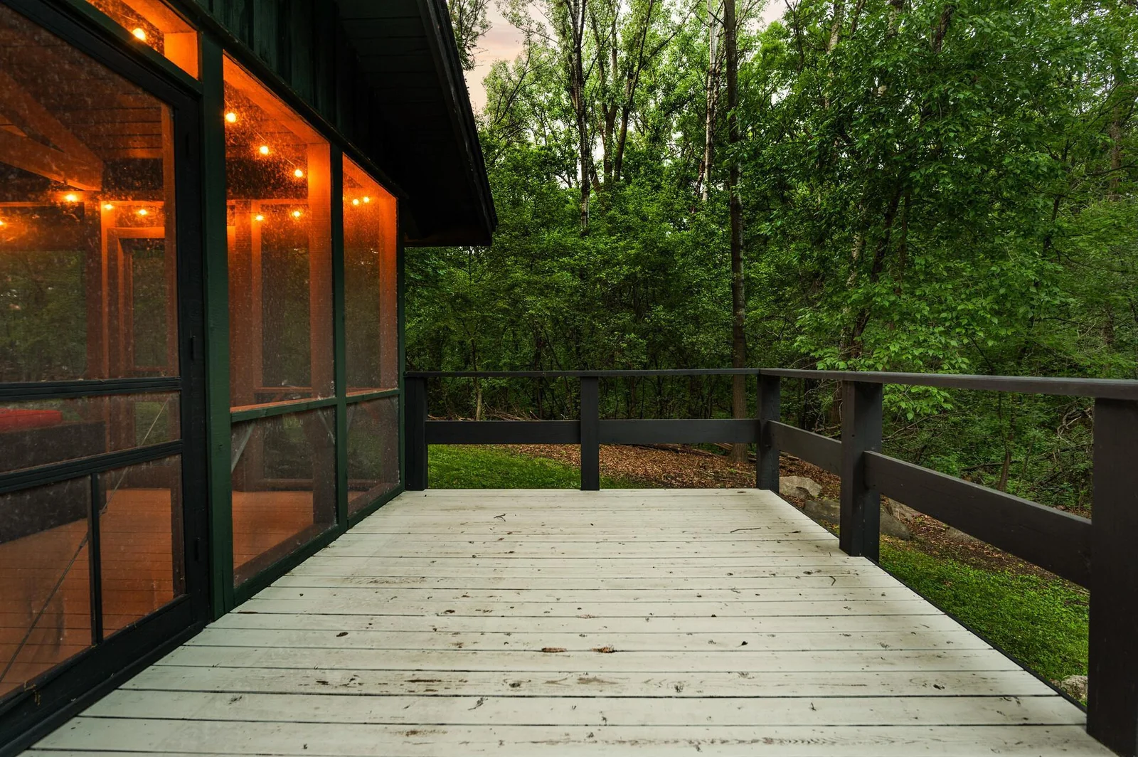 New deck off the screened in porch provides additional outdoor seating area overlooking mature trees that surround your property.