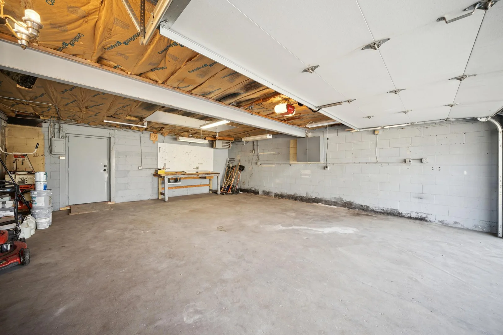 Interior of the attached garage highlighting the steel beam on the ceiling which would allow for an addition to the home over the garage.