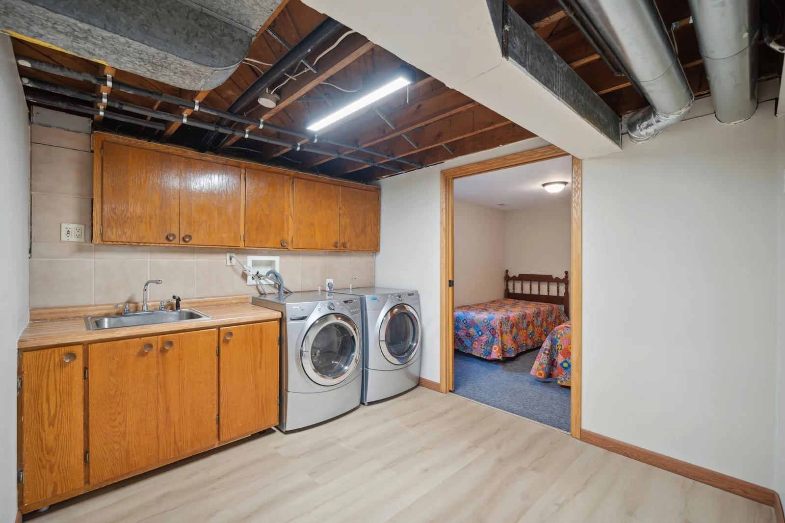 14. Lwer level Laundry room with sink and storage cabinets