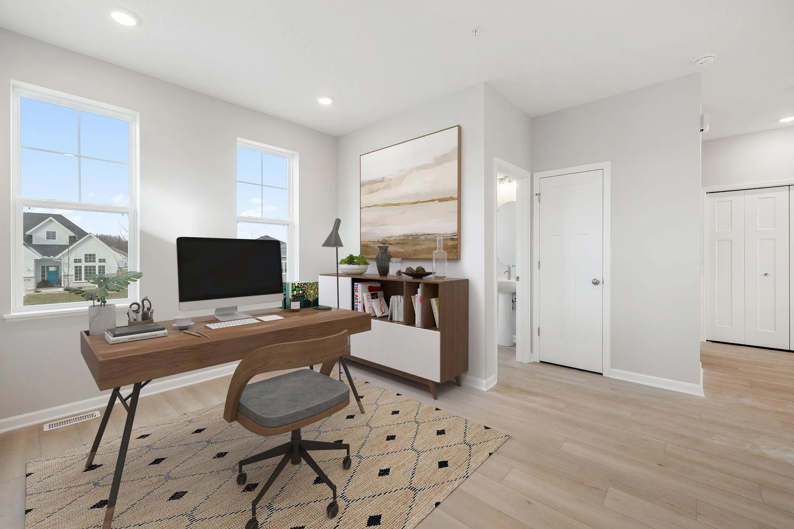 Main level flex room, virtually staged like a home office.