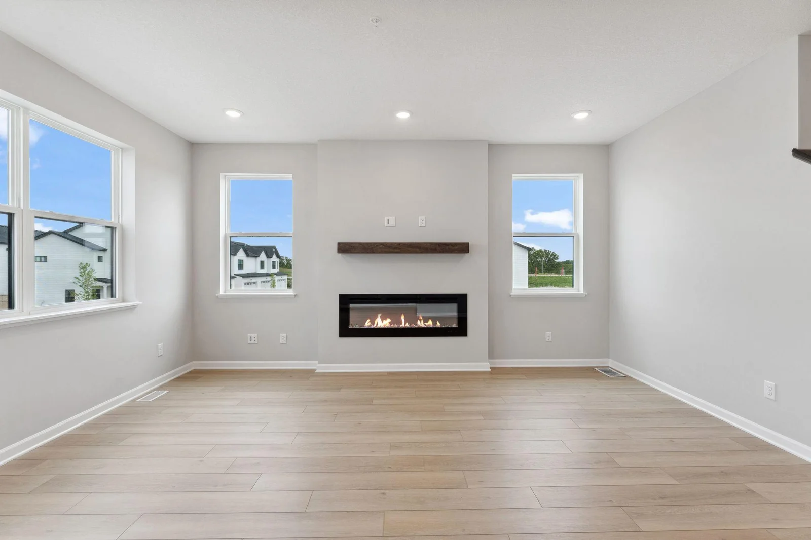 Family room with fireplace and box mantel.