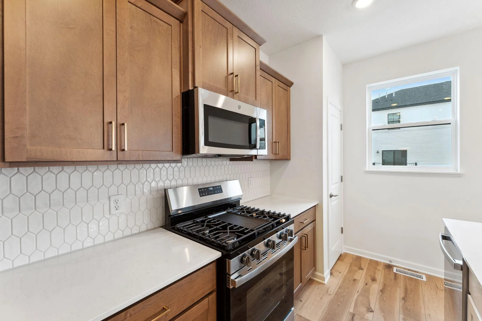 Popular stained cabinetry with brushed gold hardware