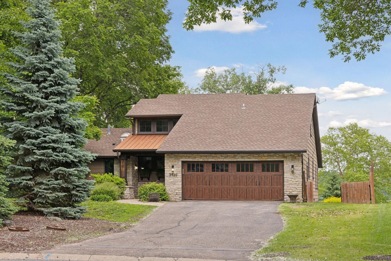 Stacked stone and designer garage door add to the curb appeal.