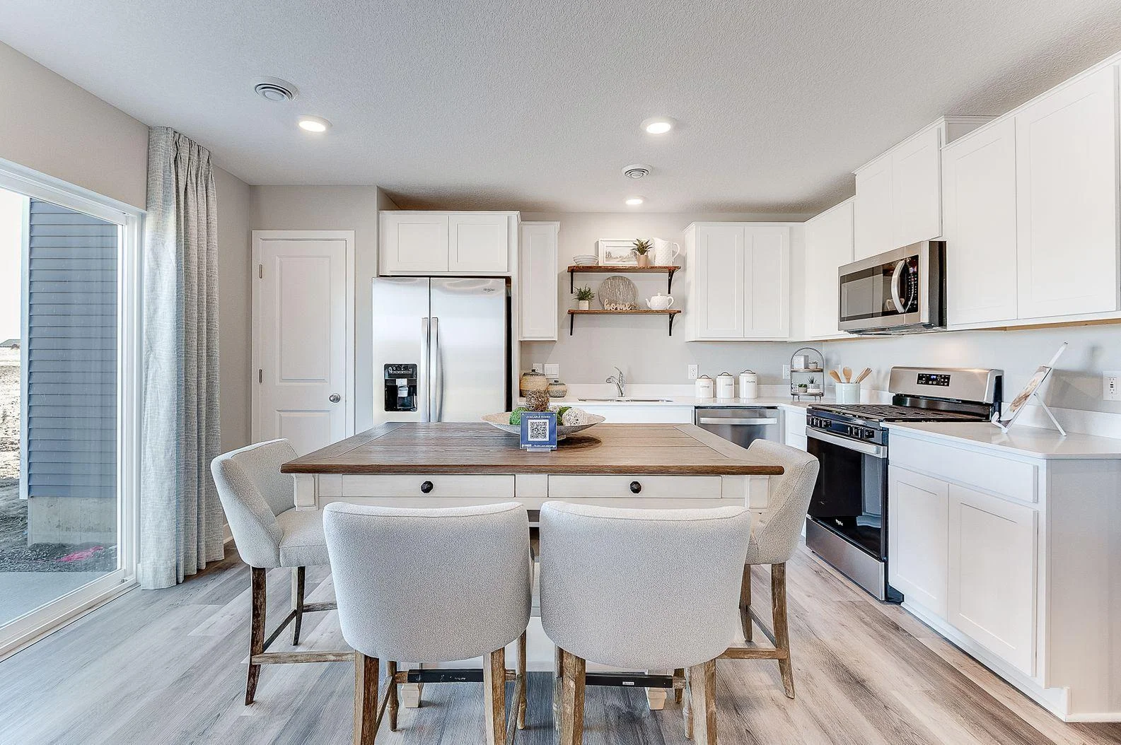 Thoughtfully designed kitchen with stainless appliance package including gas range, dishwasher and vented micro-hood. (Model photo, colors may vary)