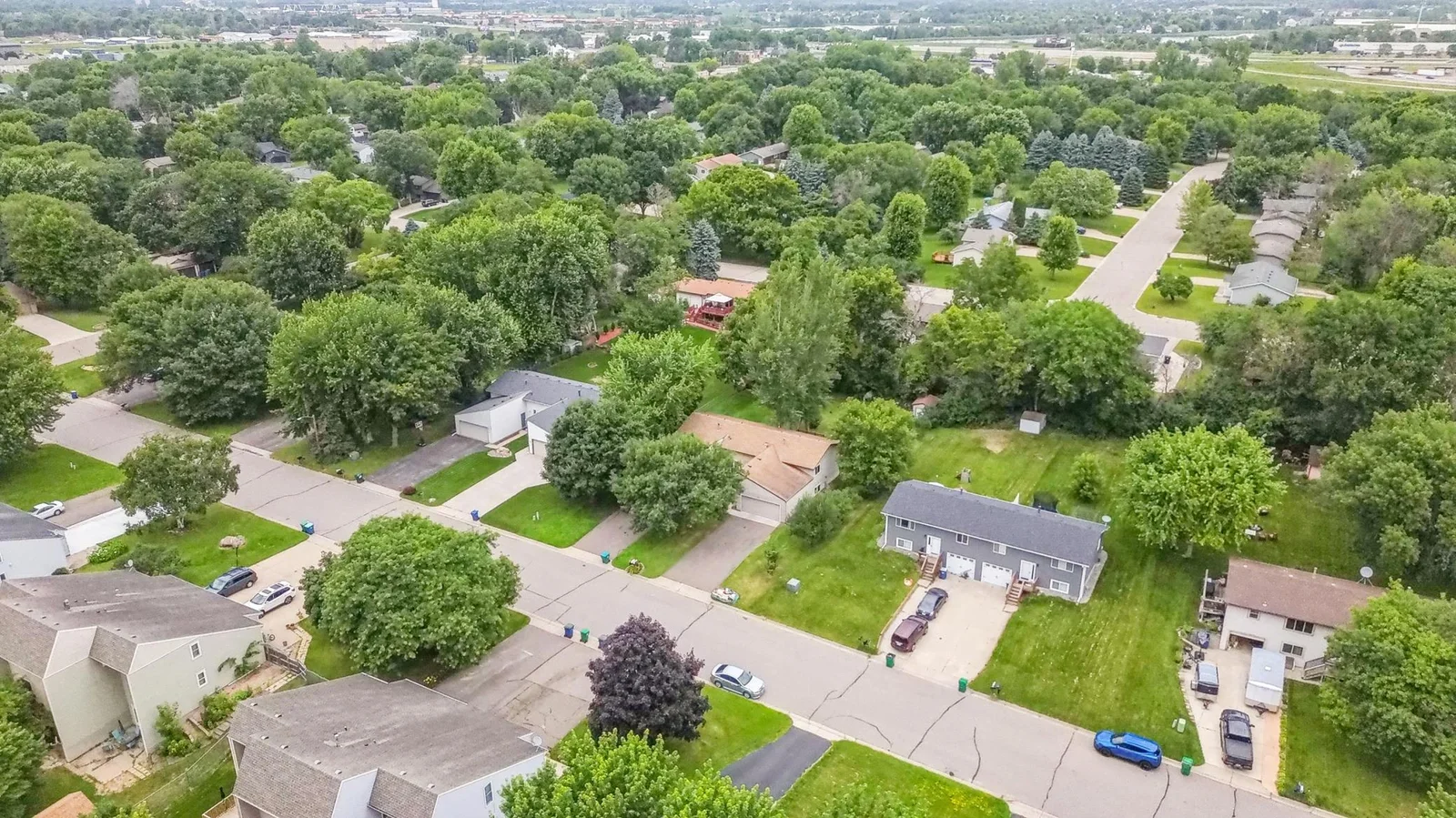 This home is in a neighborhood of mature trees and twin homes.