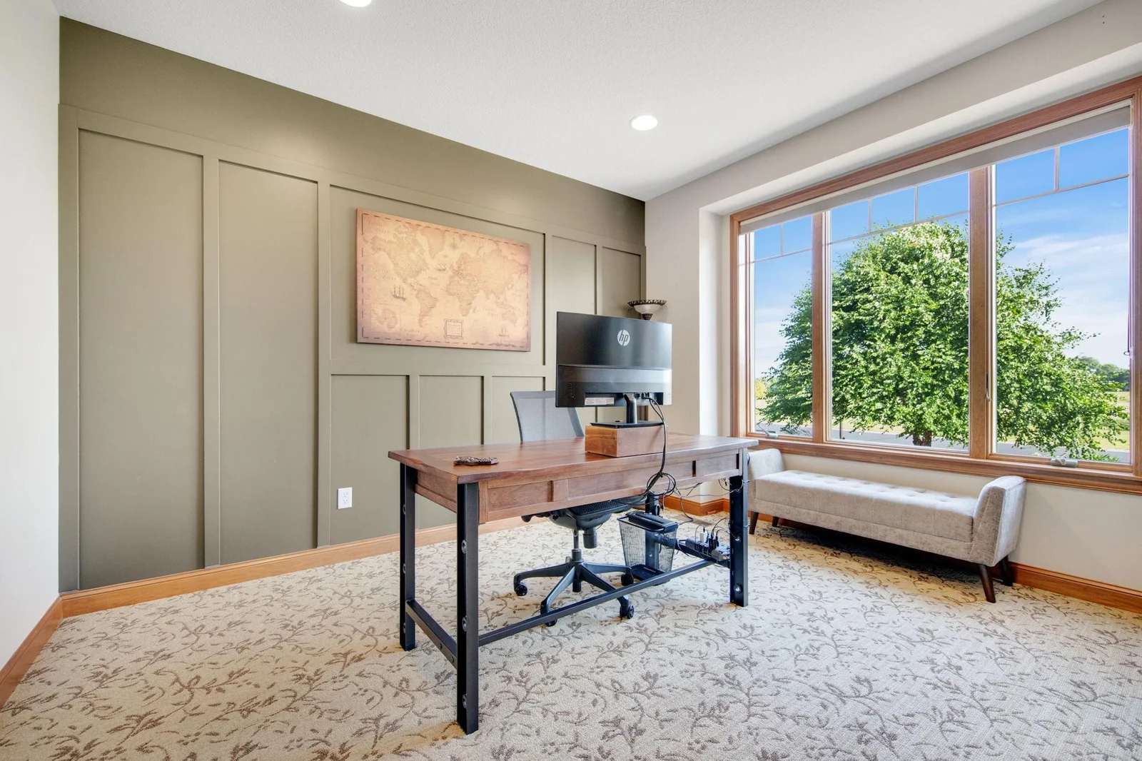 Main floor office with board and batten accent wall and large picture window!