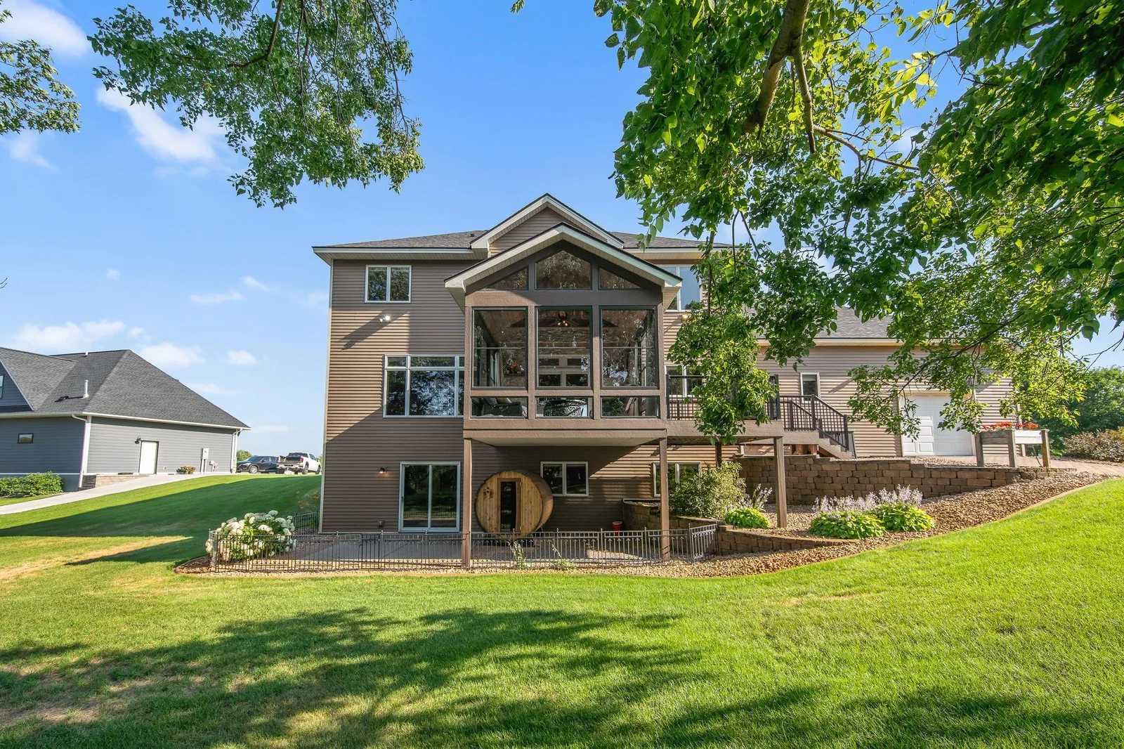 The 3 season porch of your dreams, maintenance free deck, walkout lower level, back garage, and so much more!