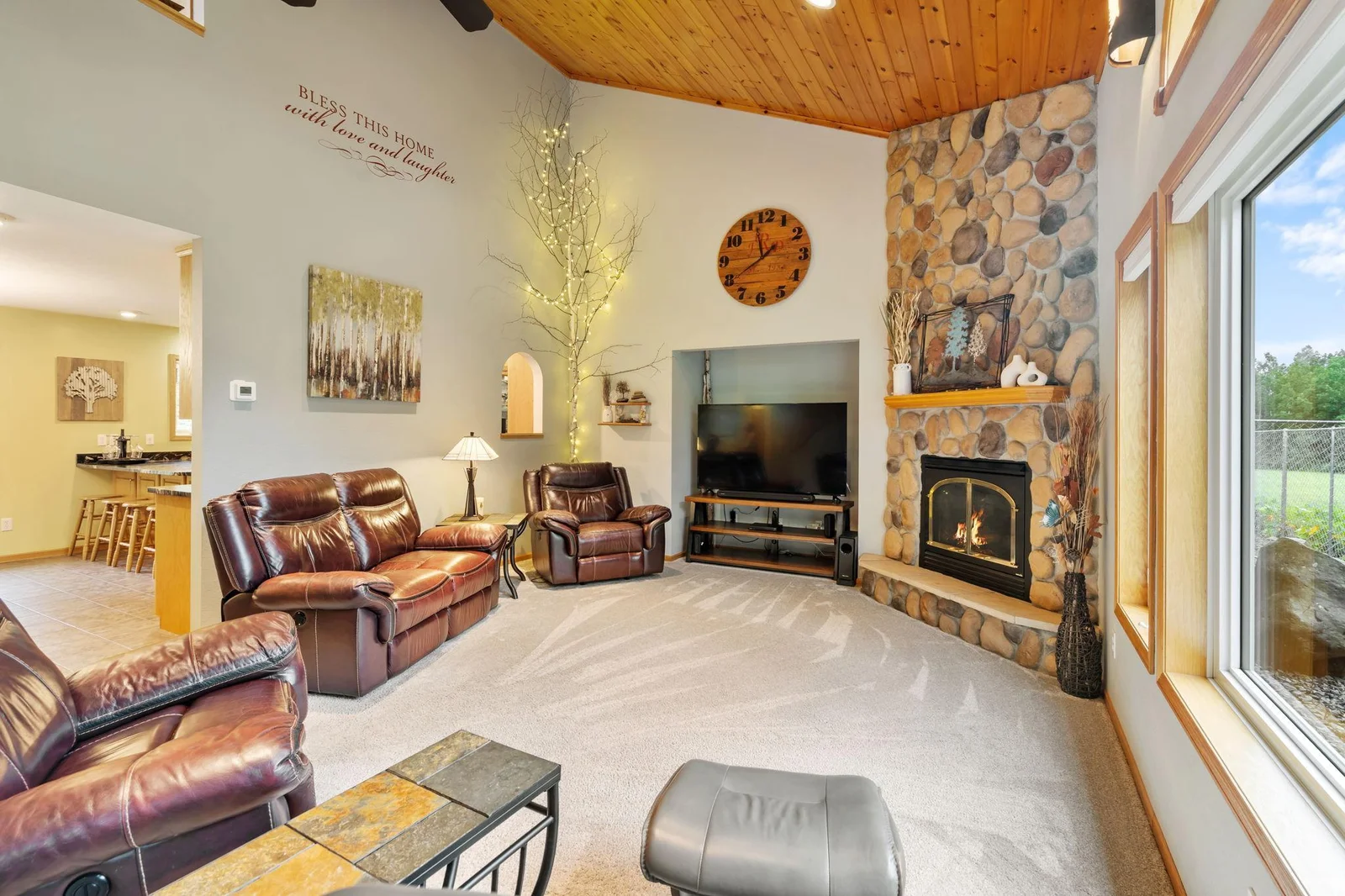 Large windows, gas fireplace & wood ceiling