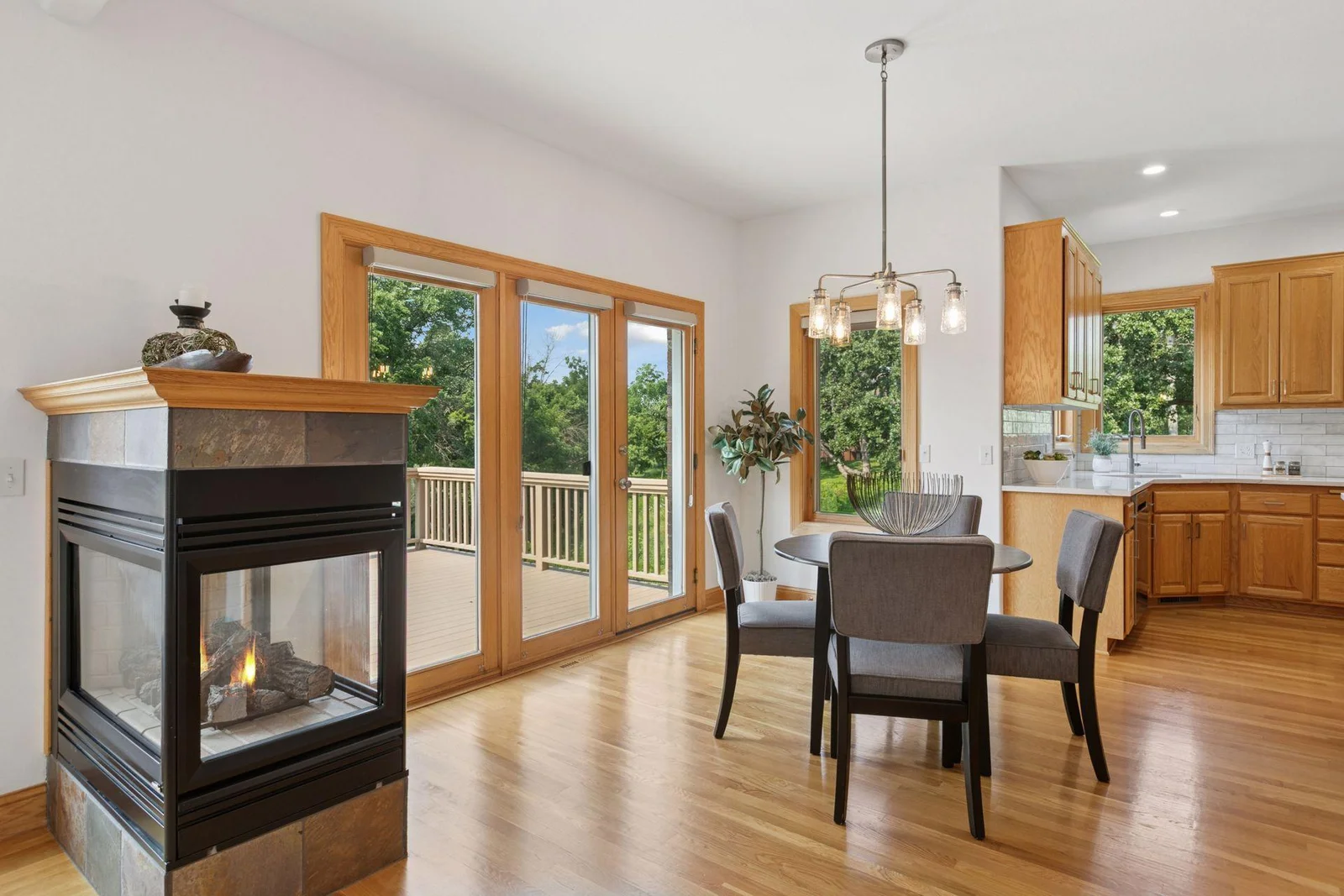 Feel cozy with the three-sided gas fireplace as you eat or relax