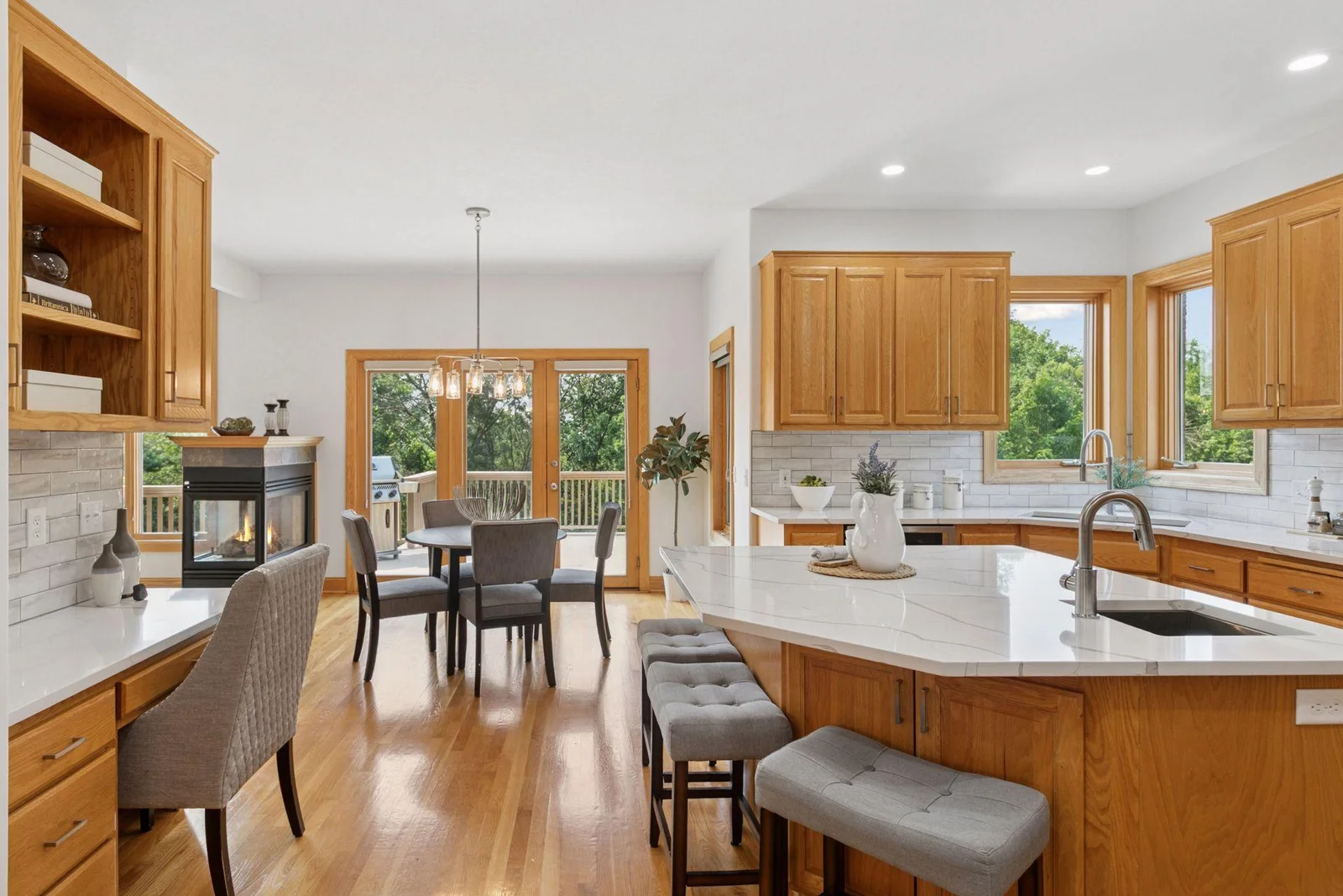 Natural stone countertops and backsplash, wood floors cabinets, trim and molding--timeless